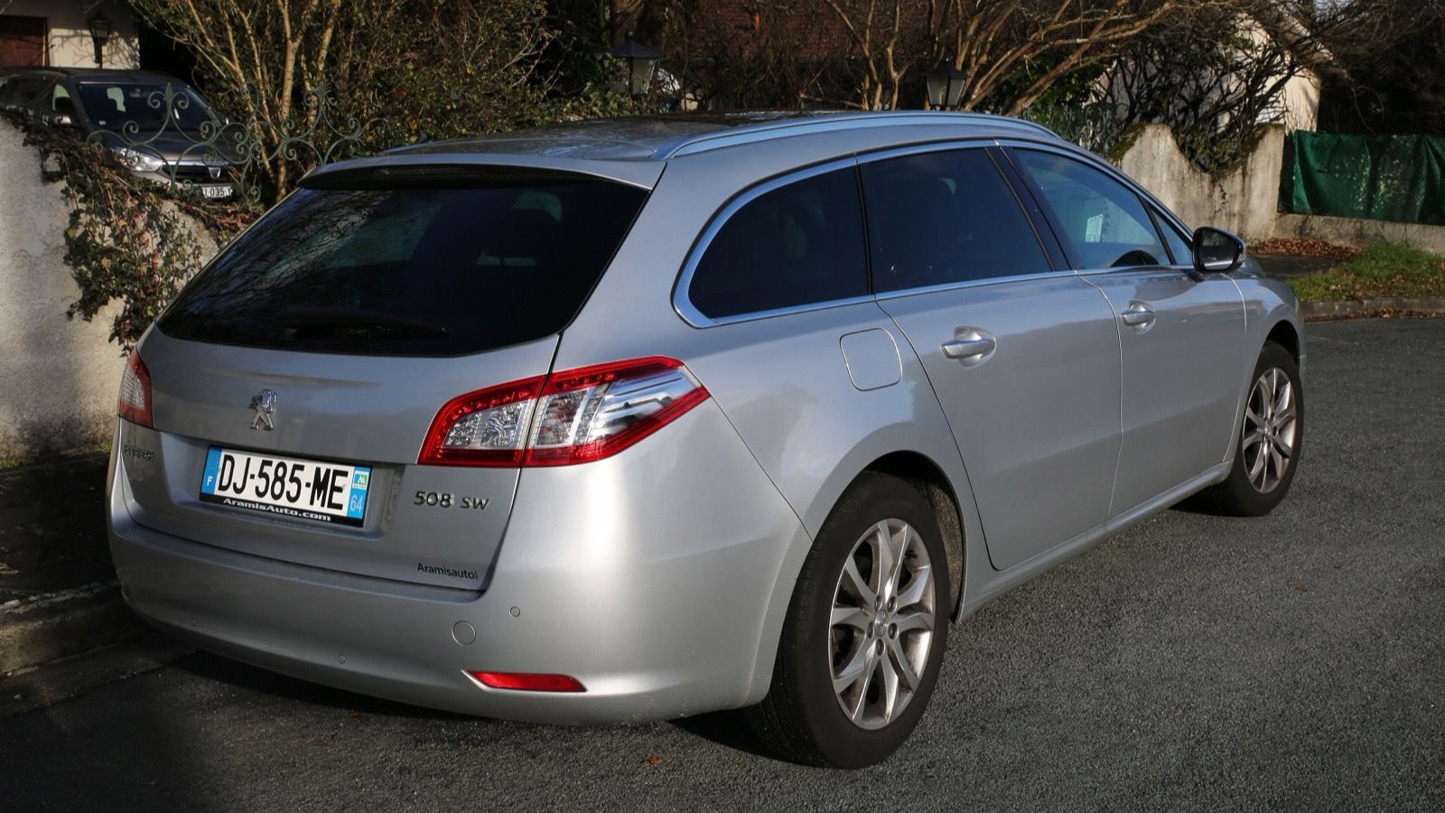 Silver 2014 Peugeot 508 SW estate, rear three-quarter view