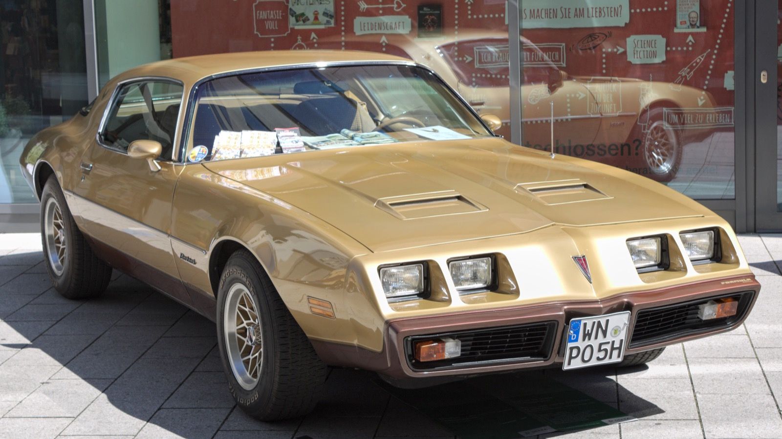 Late second-generation Pontiac Firebird — gold coupe, front three-quarter view