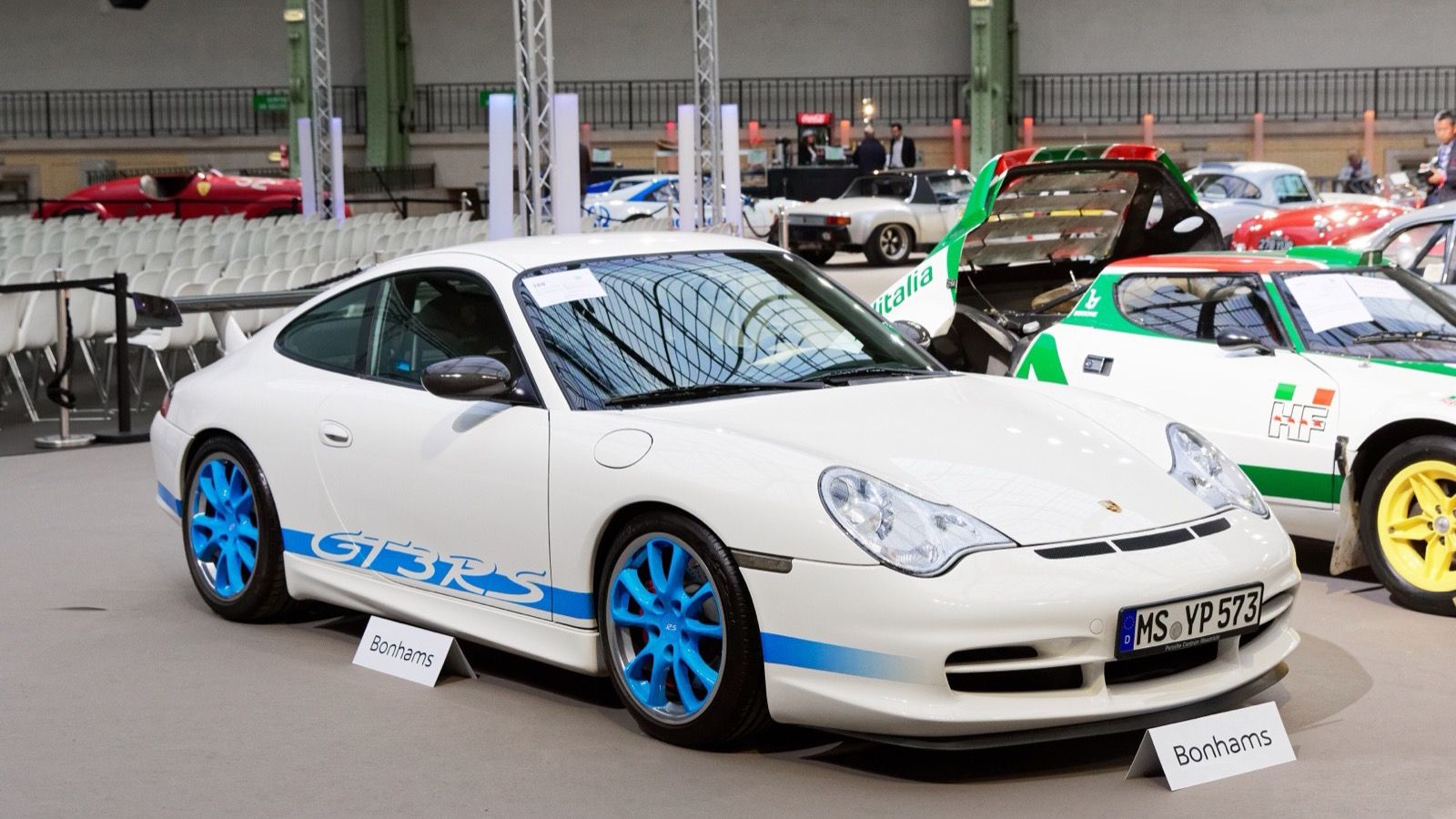 White 2003 Porsche 911 (996) GT3 RS with blue graphics, front three-quarter view