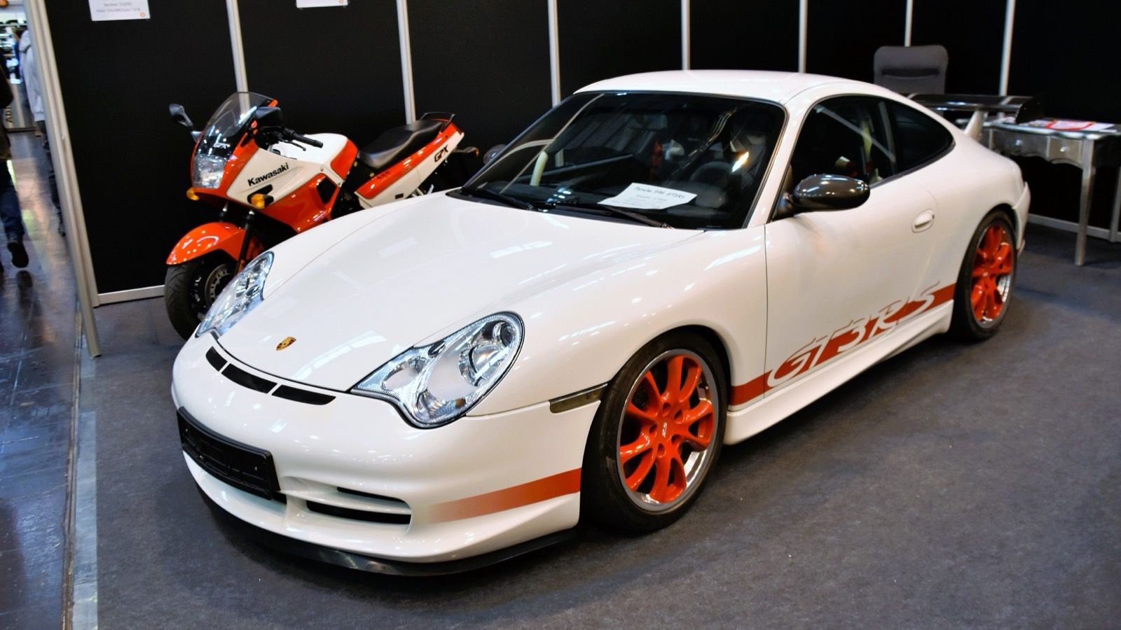 White 2004 Porsche 911 (996.2) GT3 RS with red wheels, front three-quarter view