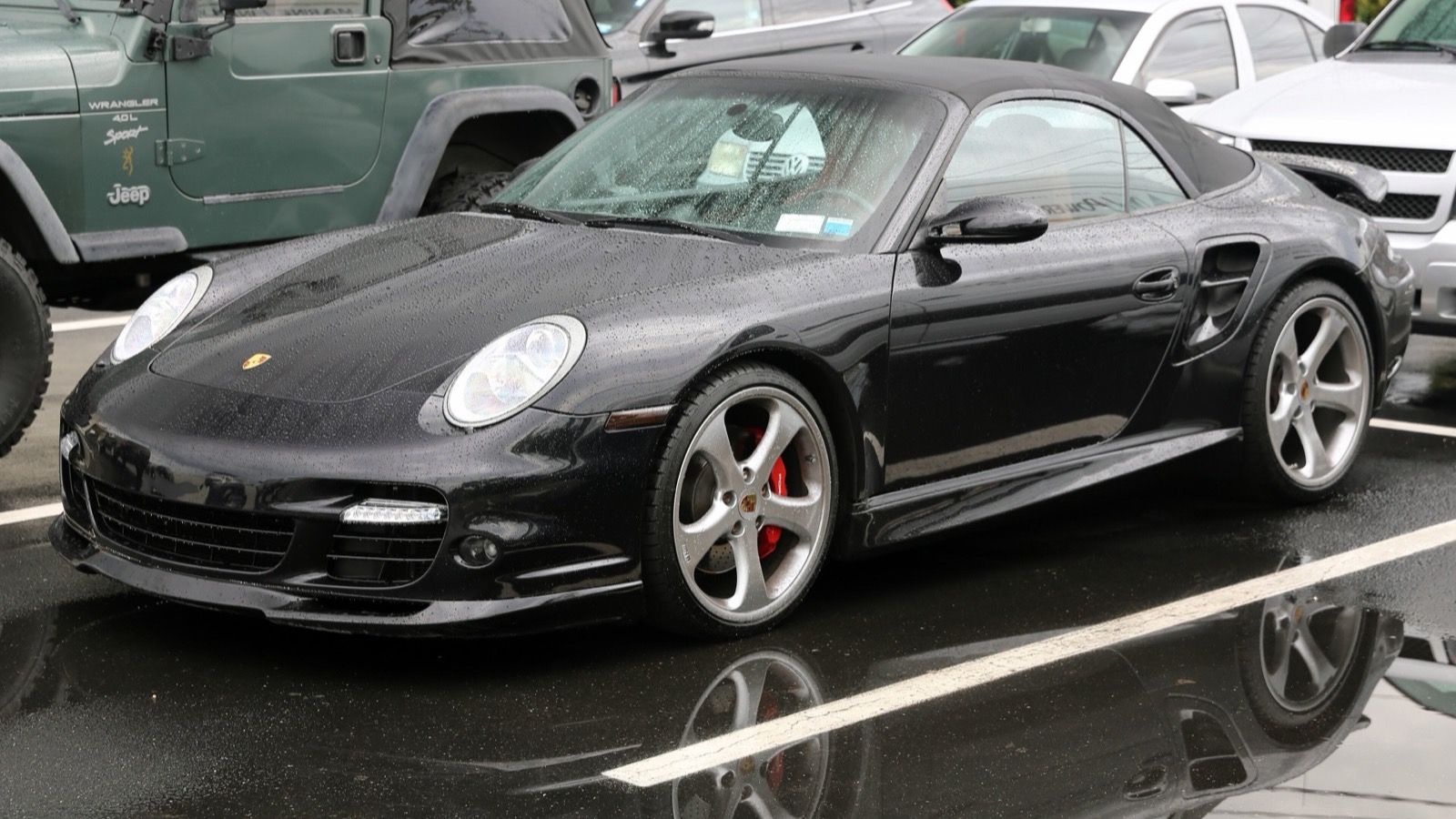 Black 2008 Porsche 911 (997) Turbo Cabriolet with roof up, front three-quarter view