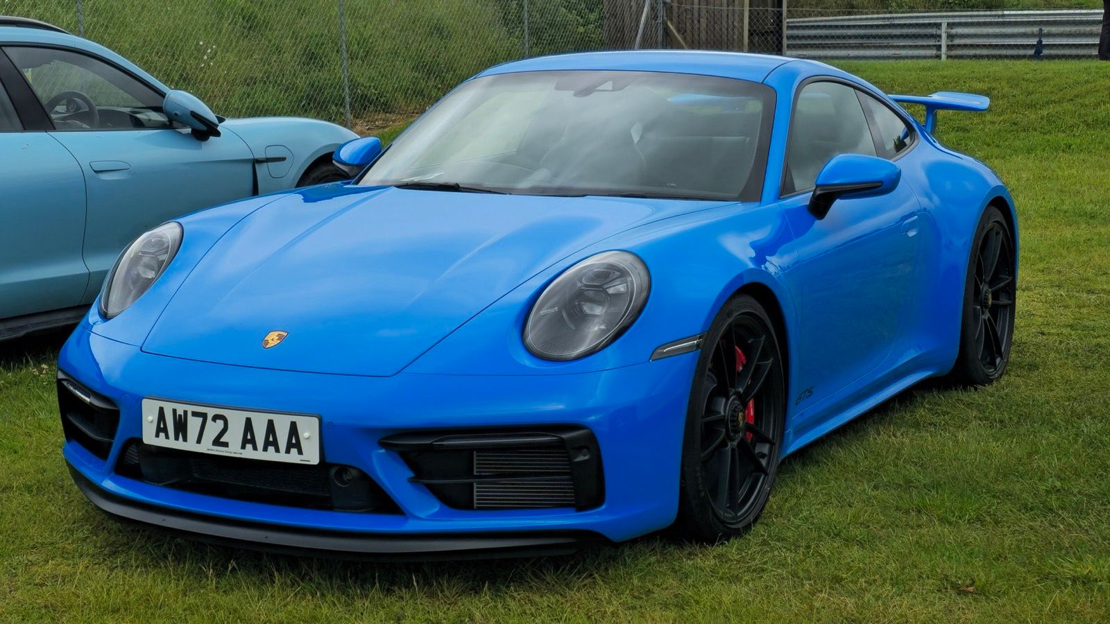 Blue 2022 Porsche 911 (992) Carrera GTS coupe, front three-quarter view