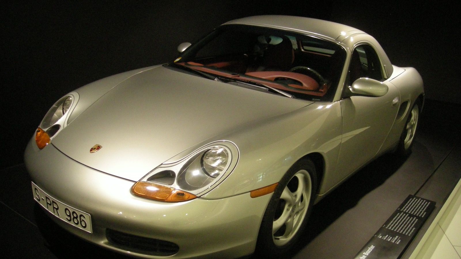 Silver 1996 Porsche Boxster (986) roadster on museum display, front three-quarter view