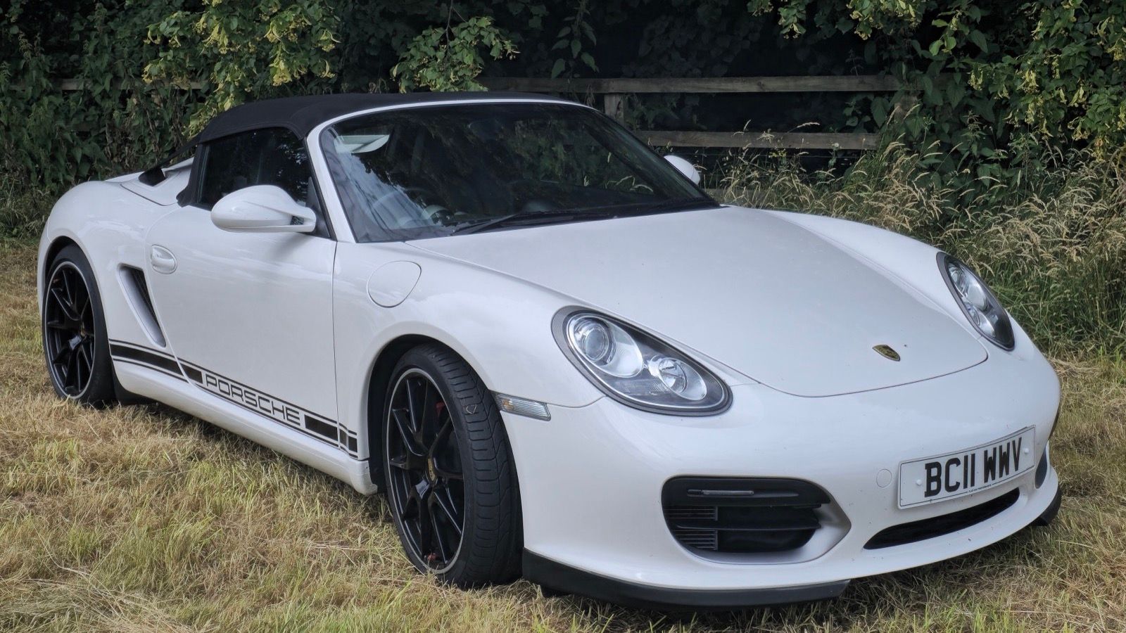 White 2011 Porsche Boxster Spyder (987) with roof up, front three-quarter view