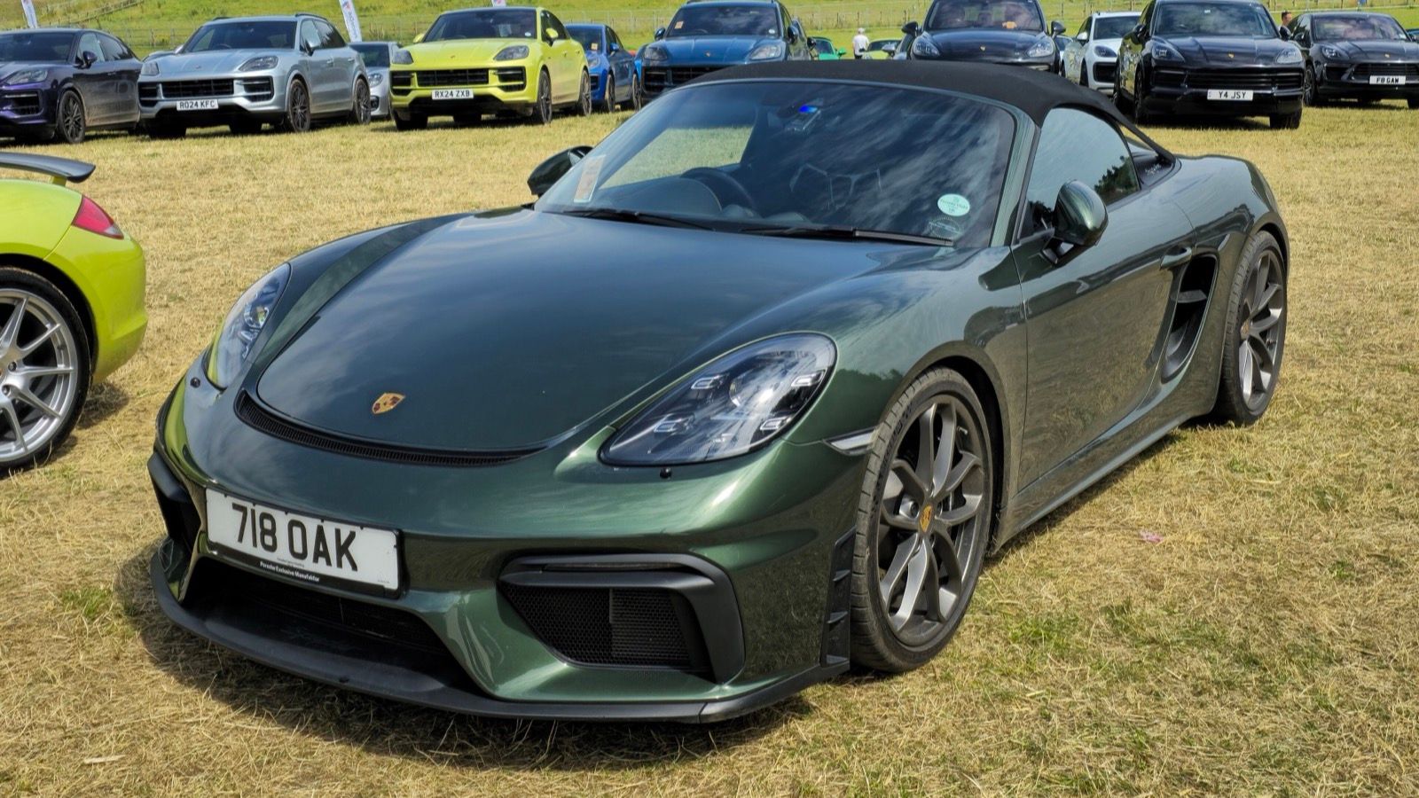 Dark green 2021 Porsche 718 Spyder roadster, front three-quarter view