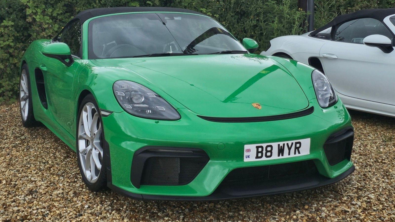 Green 2022 Porsche 718 Spyder roadster, front three-quarter view