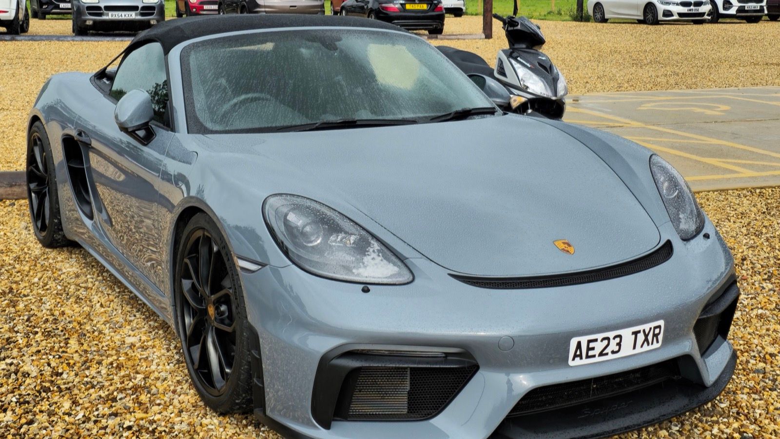 Grey 2023 Porsche 718 Spyder roadster, front three-quarter view