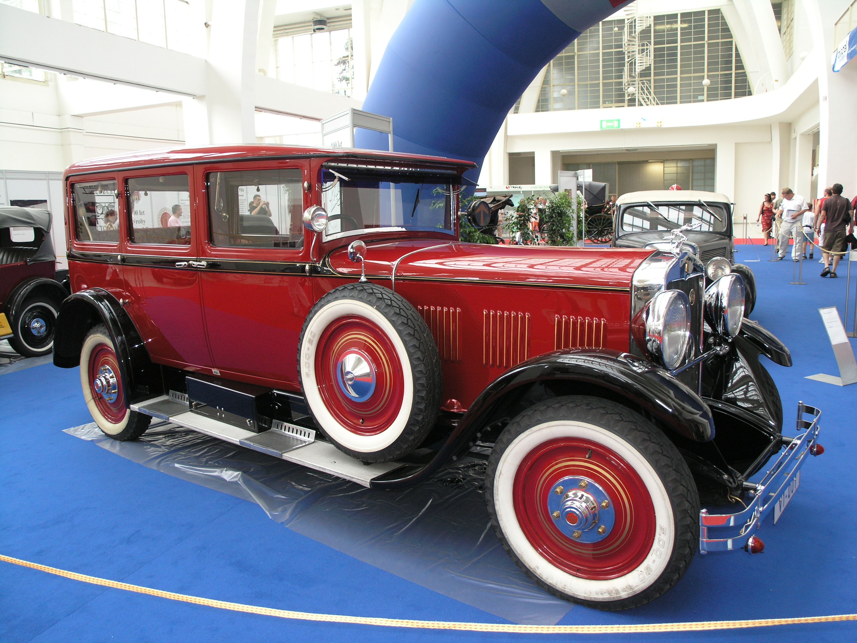 Red 1929 Praga Grand saloon on indoor display, front three-quarter view