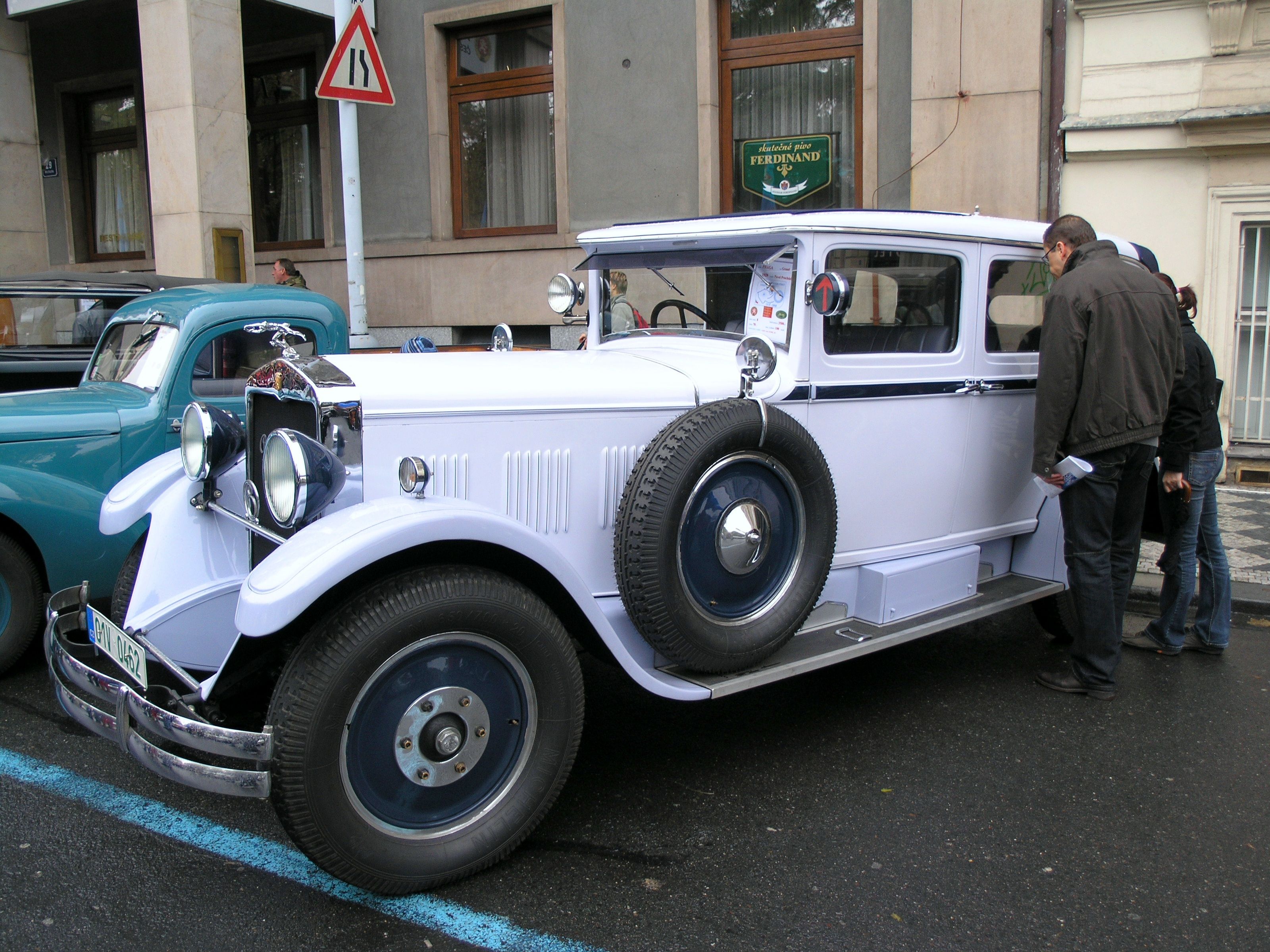 White late-series Praga Grand saloon parked on Opletalova street in Prague, front three-quarter view