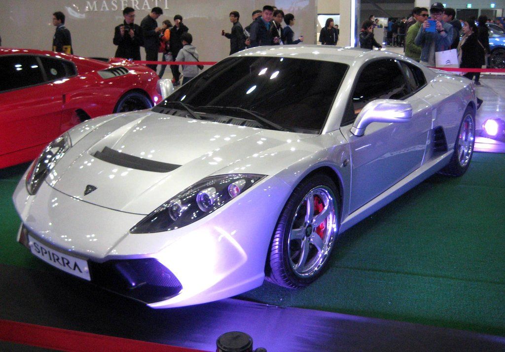 Silver Oullim Spirra EX on a motor show stand, front three-quarter view