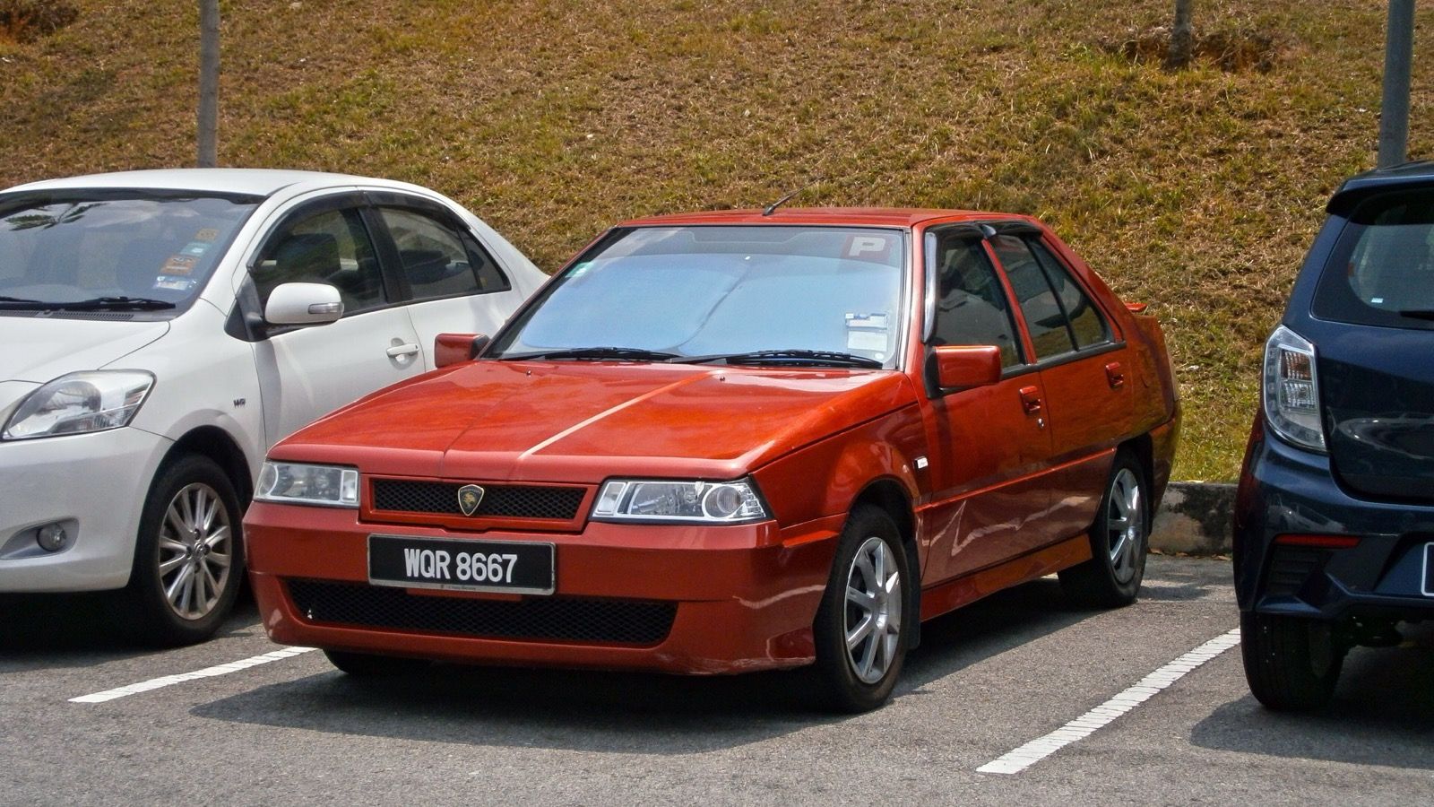 Red 2007 Proton Saga LMST 1.3 SE five-door hatchback, front three-quarter view