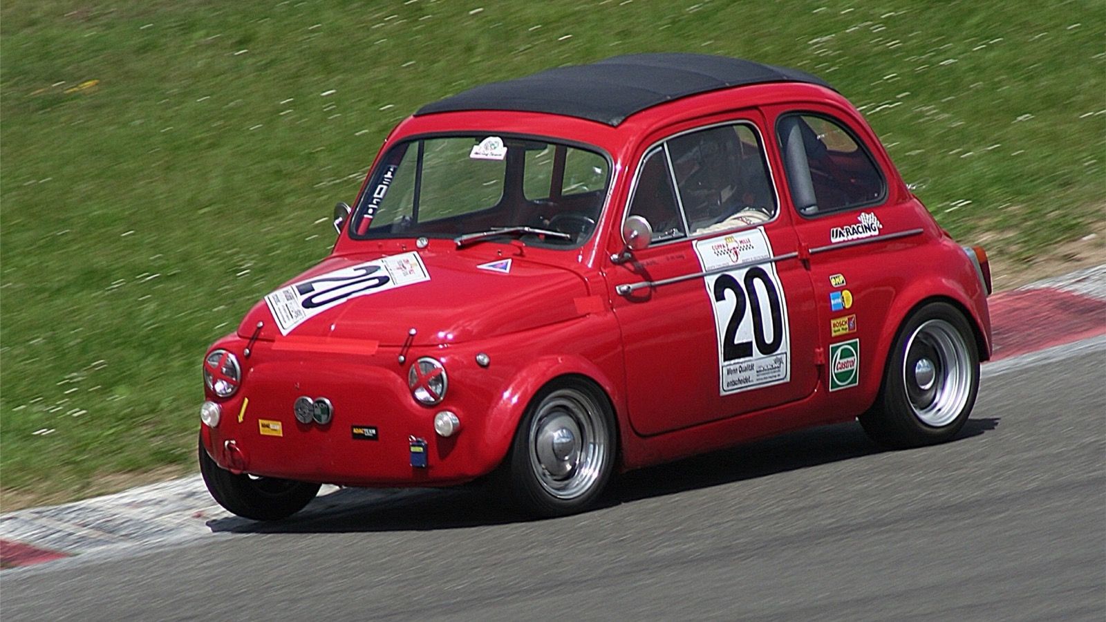 Red 1964 Steyr-Puch 650 TR competing on a circuit, front three-quarter view