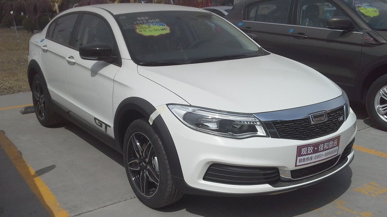 White Qoros 3 GT on a dealer forecourt, front three-quarter view