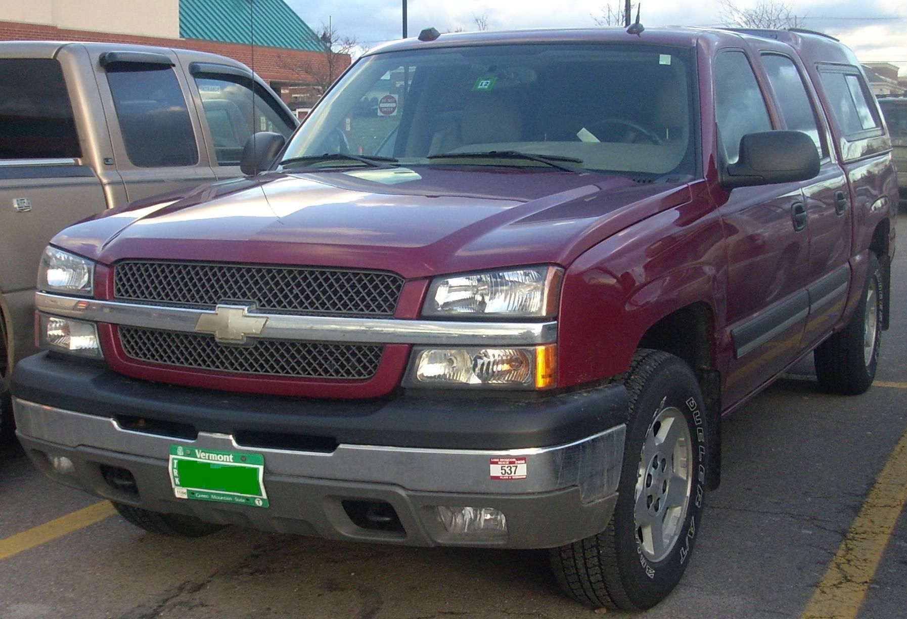 Red 2003–2005 Chevrolet Silverado Crew Cab with a bed cap, representative photograph