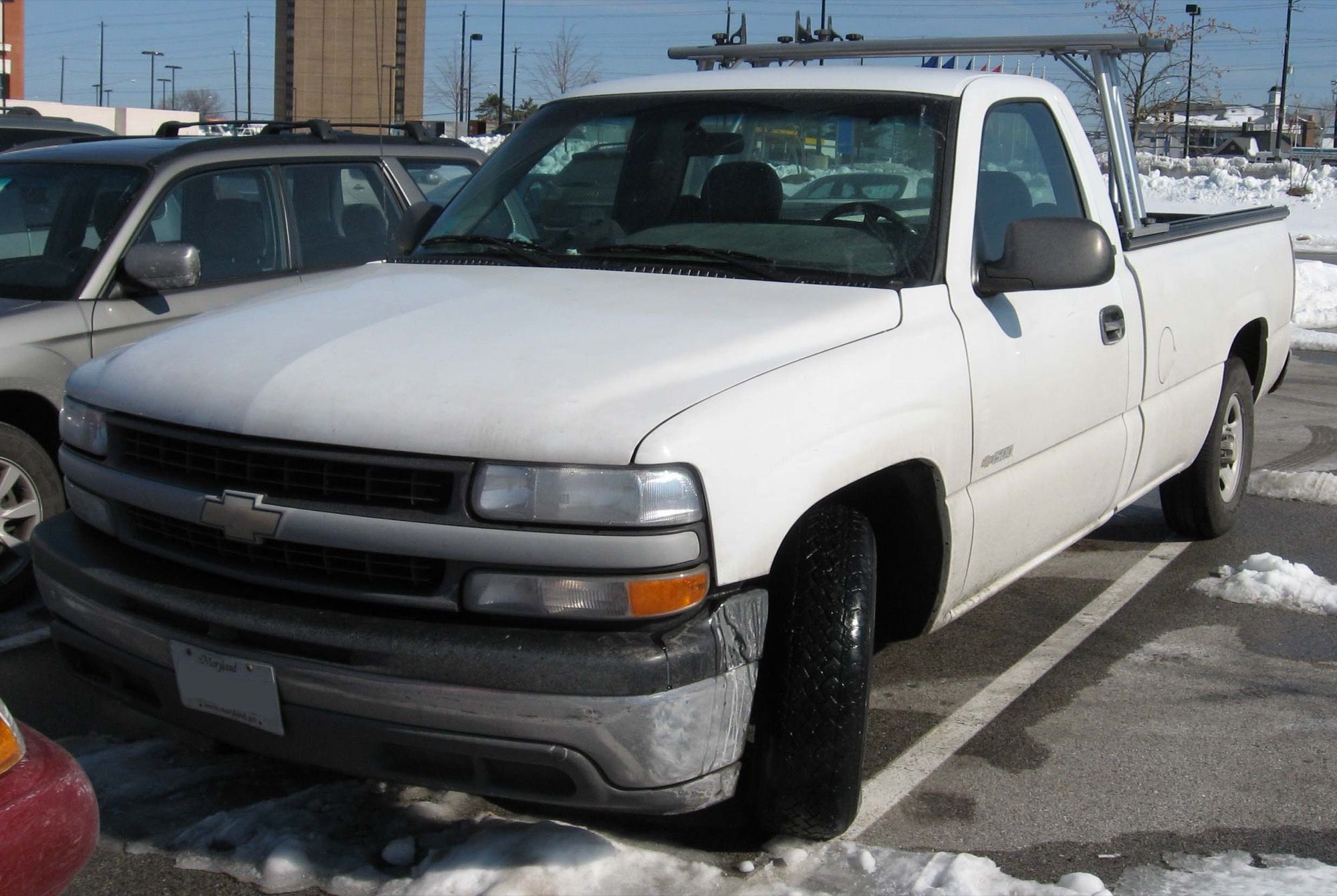 White 1999–2002 Chevrolet Silverado Regular Cab with a ladder rack, representative photograph