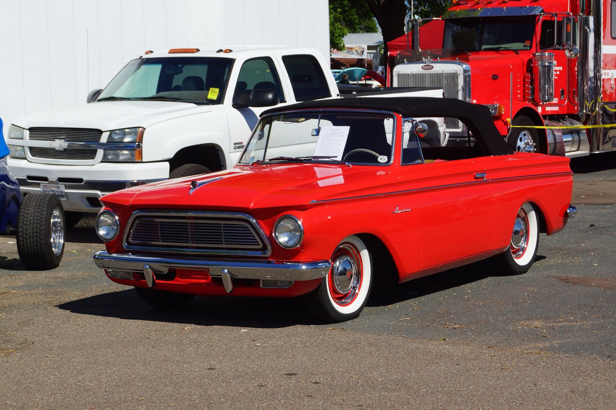 Red 1962 Rambler American 400 convertible with black top, front three-quarter view