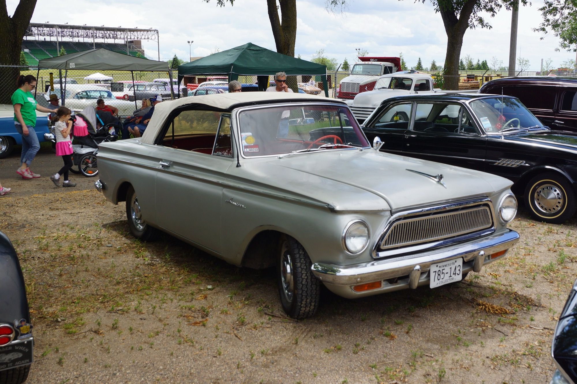 Silver 1963 Rambler American 440 convertible with cream top raised, front three-quarter view