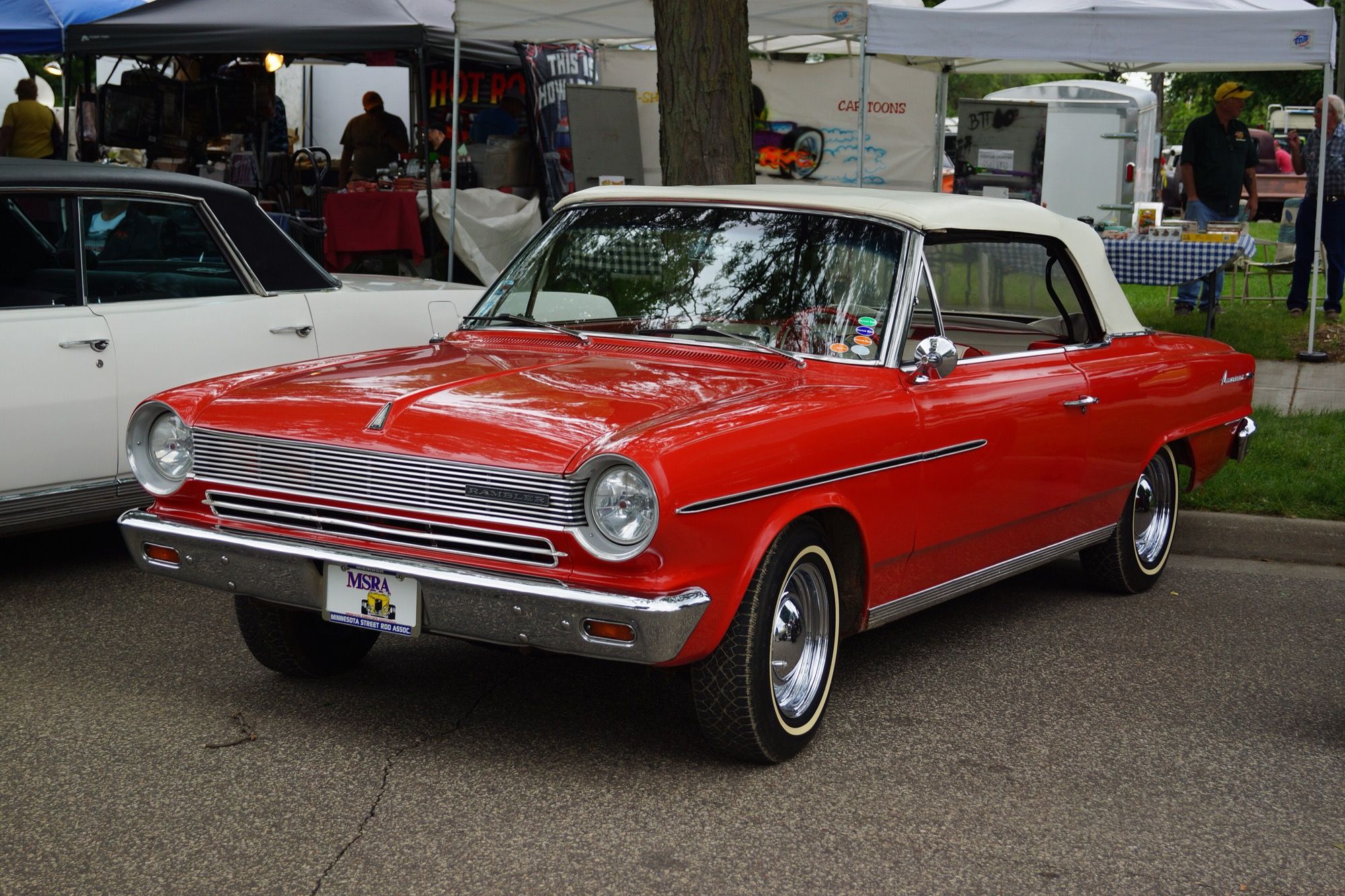 Red 1964 Rambler American 440 convertible with white top raised, front three-quarter view
