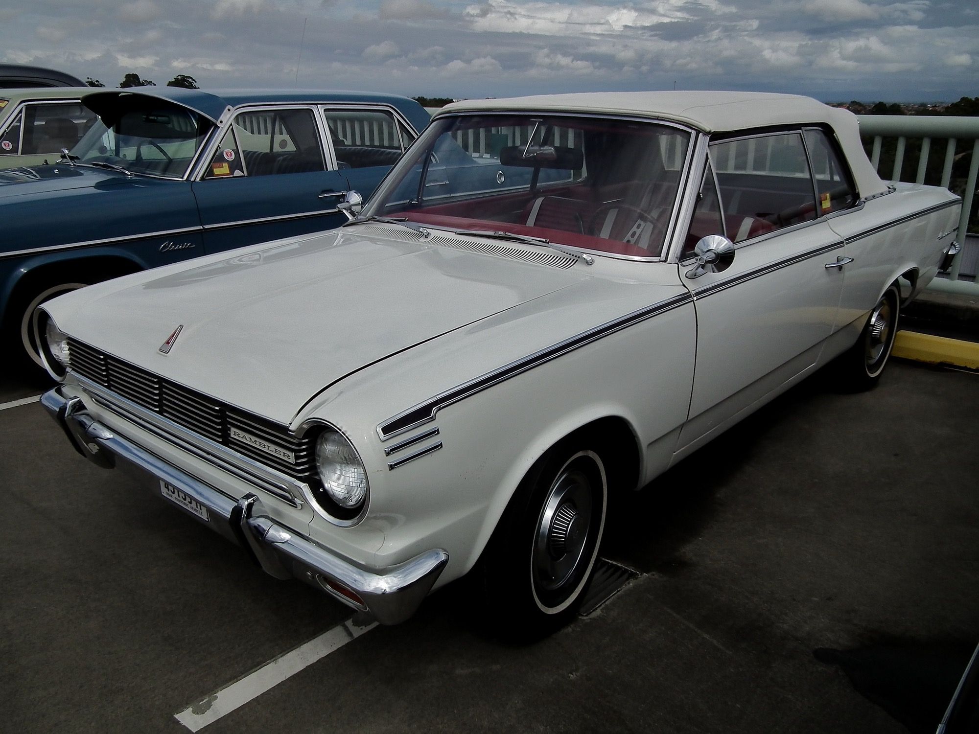 White 1965 Rambler American 440 convertible with white top raised, front three-quarter view