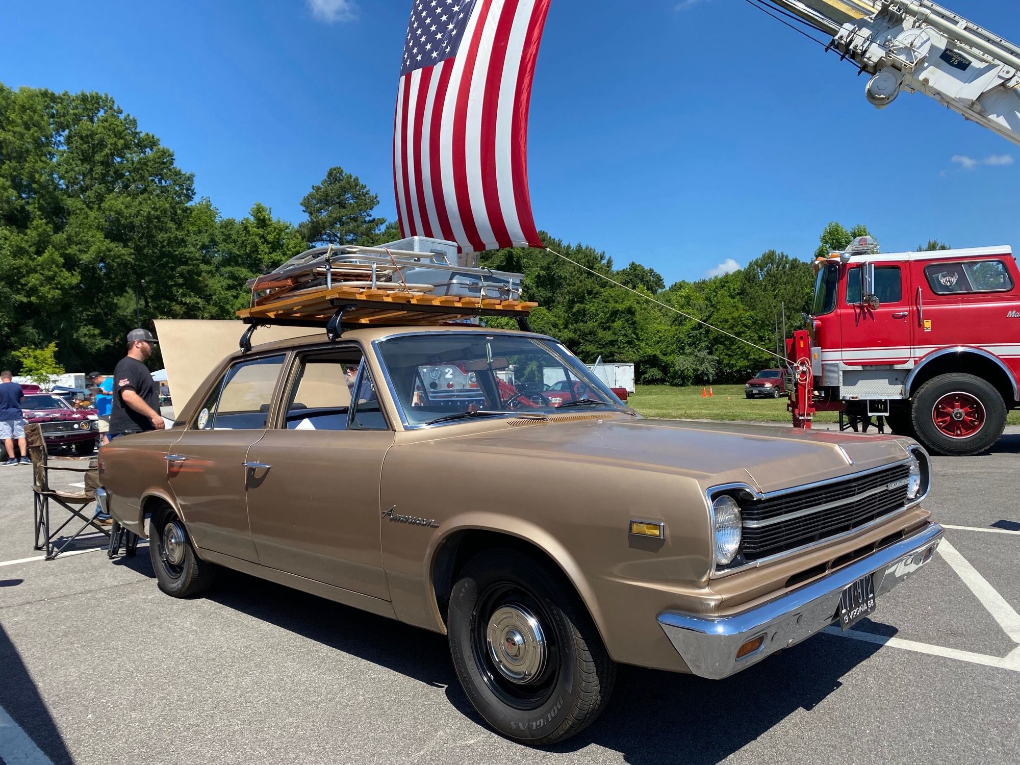 Gold 1968 Rambler American four-door sedan with roof rack, front three-quarter view