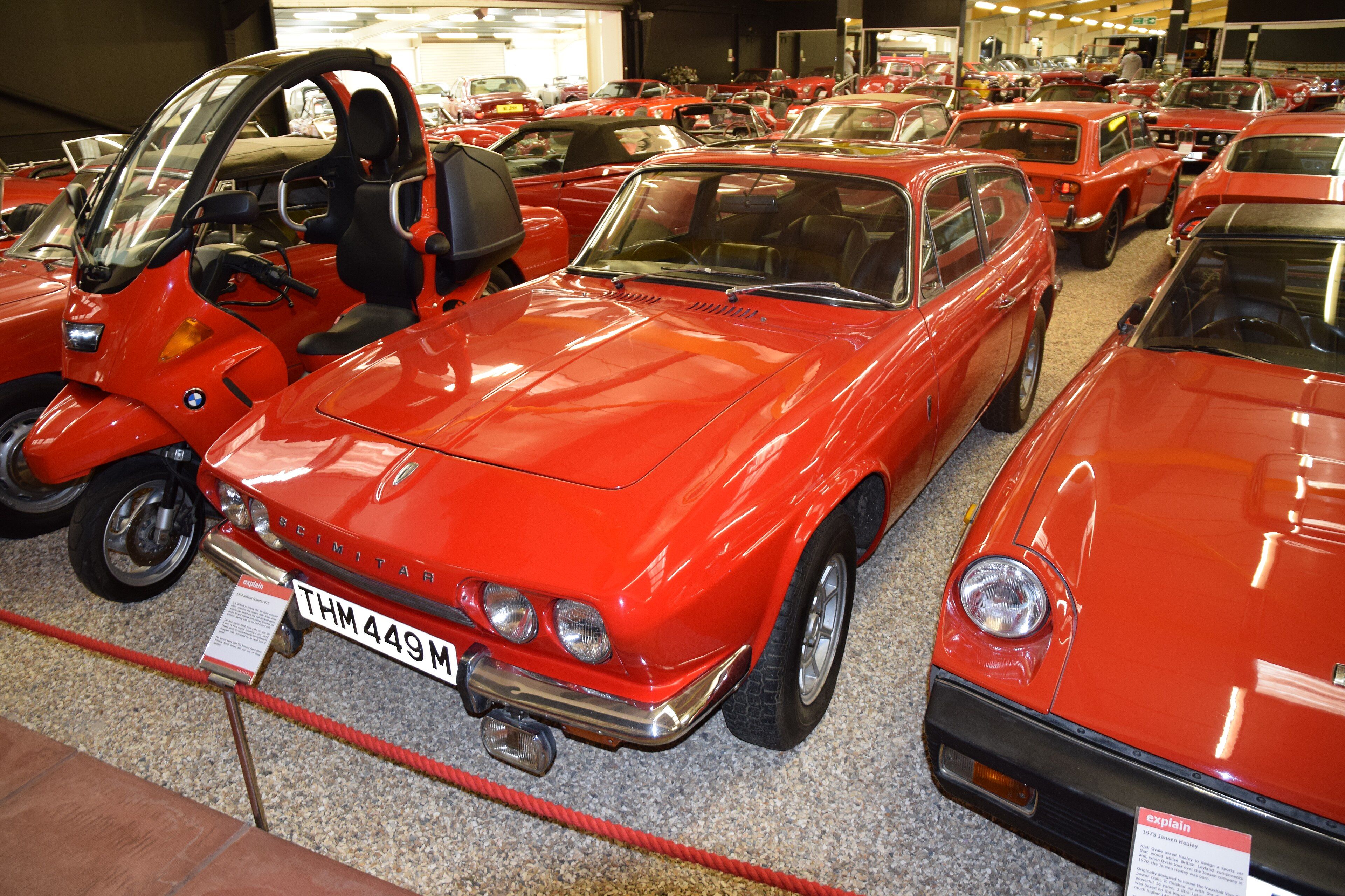 Red 1974 Reliant Scimitar GTE on museum display, front three-quarter view