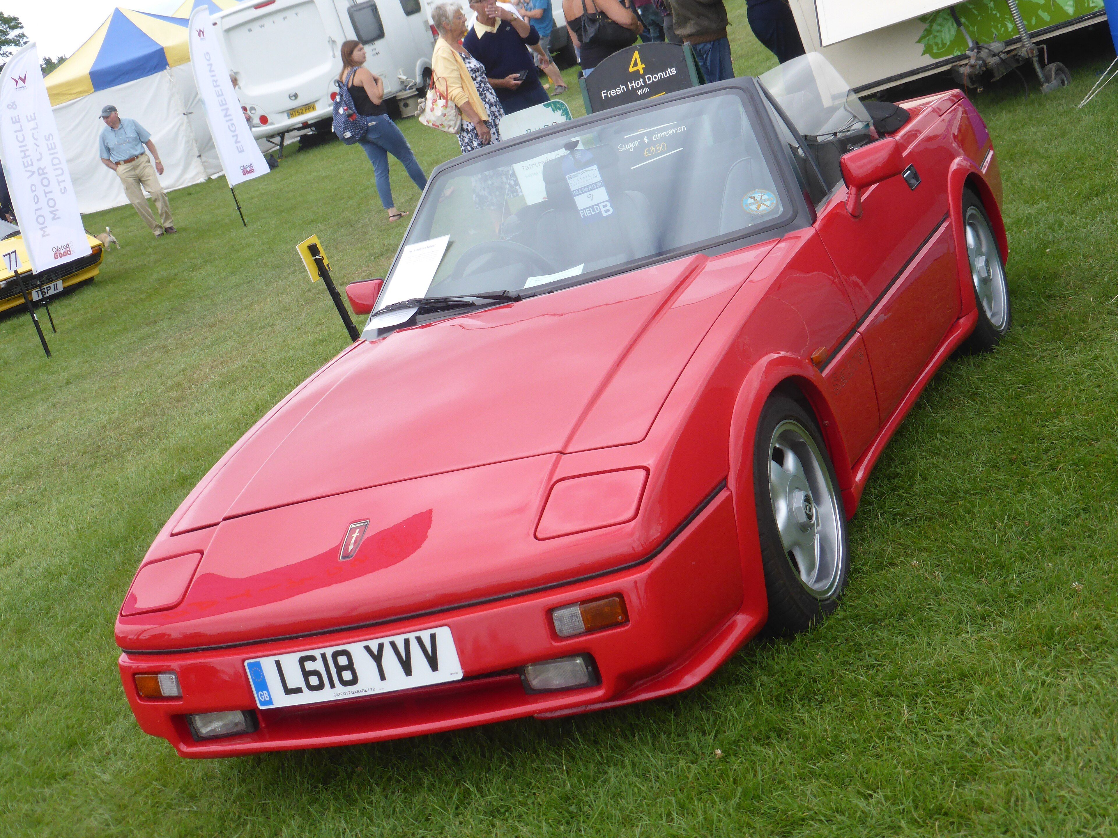 Red 1993 Reliant Scimitar Sabre 1.8 Turbo roadster on grass, front three-quarter view