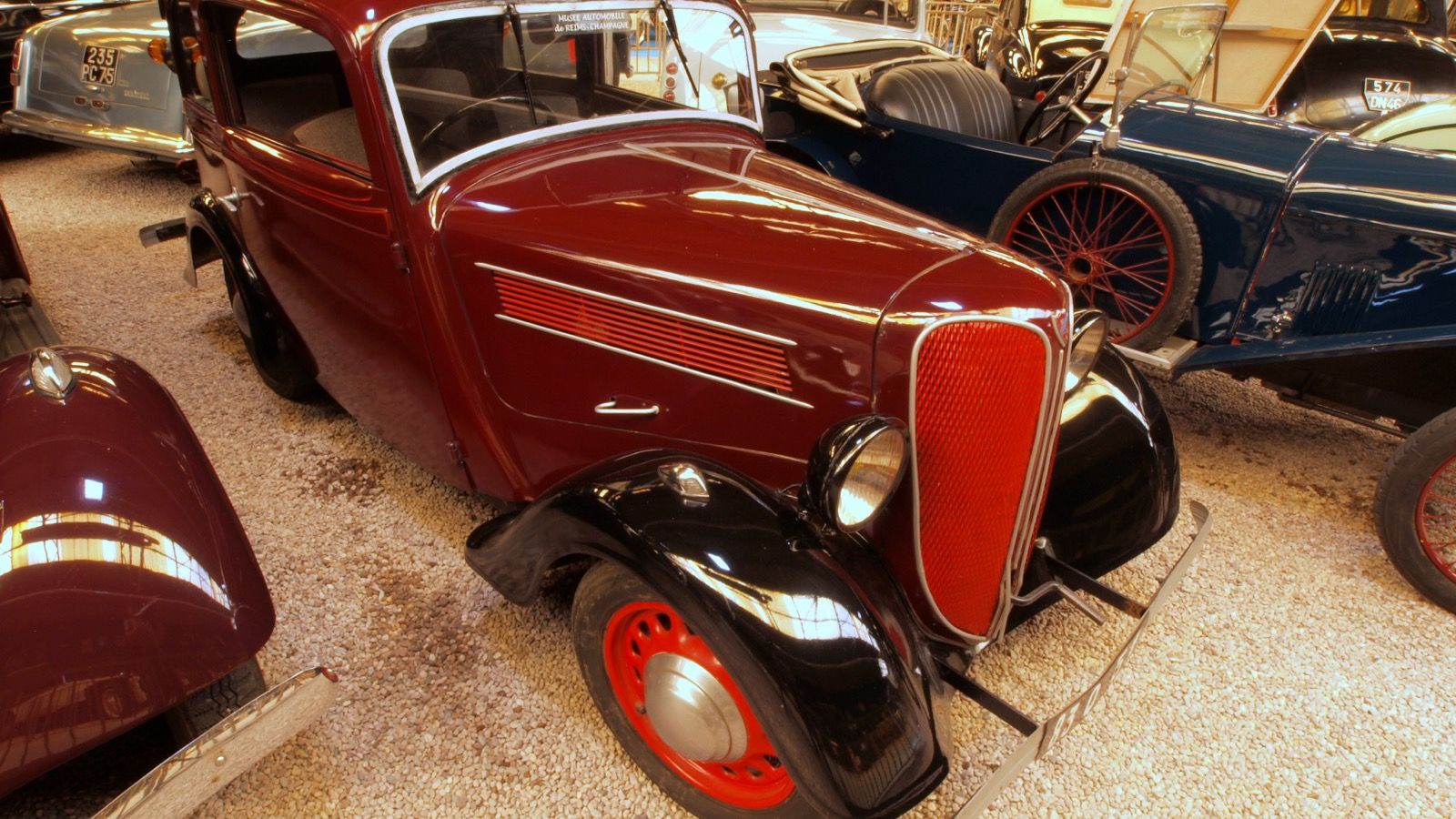 Maroon and black 1936 Rosengart LR4 N2 saloon with red grille, front three-quarter view