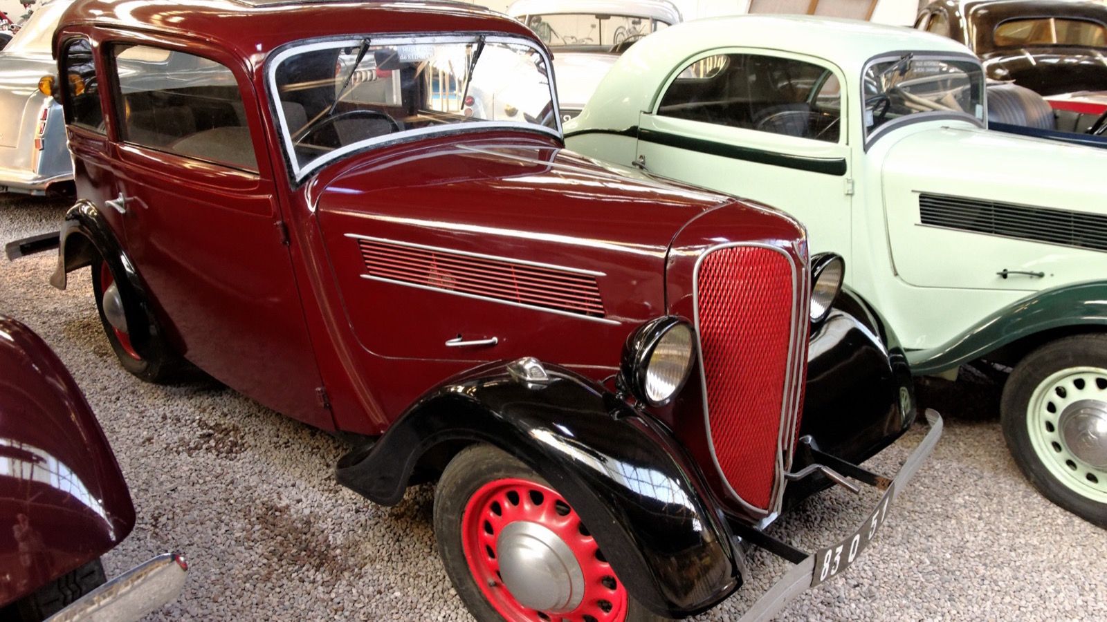 Maroon 1936 Rosengart LR4 N2 two-door saloon in a museum, front three-quarter view