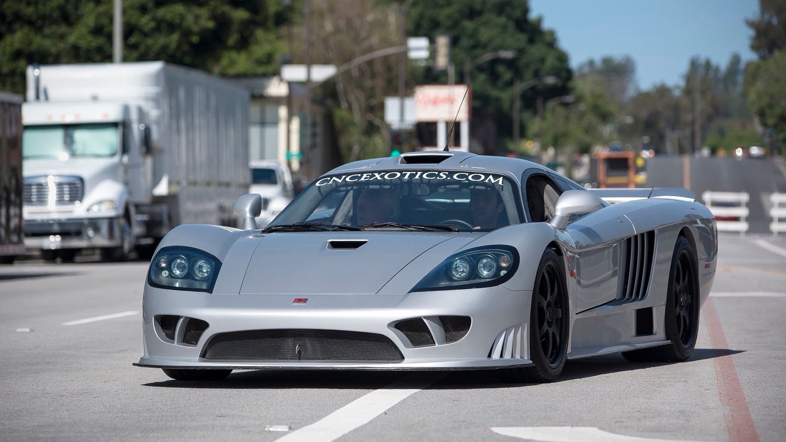 Silver Saleen S7 supercar on a public road, front three-quarter view
