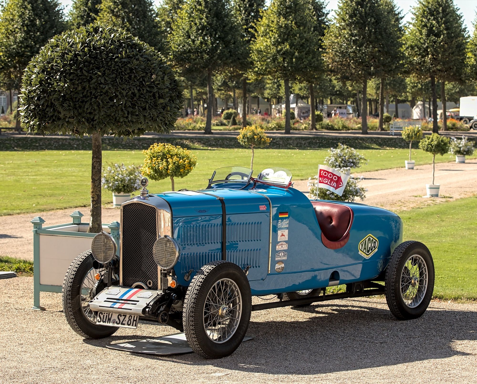 Blue 1930 Salmson S4 with sports roadster body at a concours, rear three-quarter view