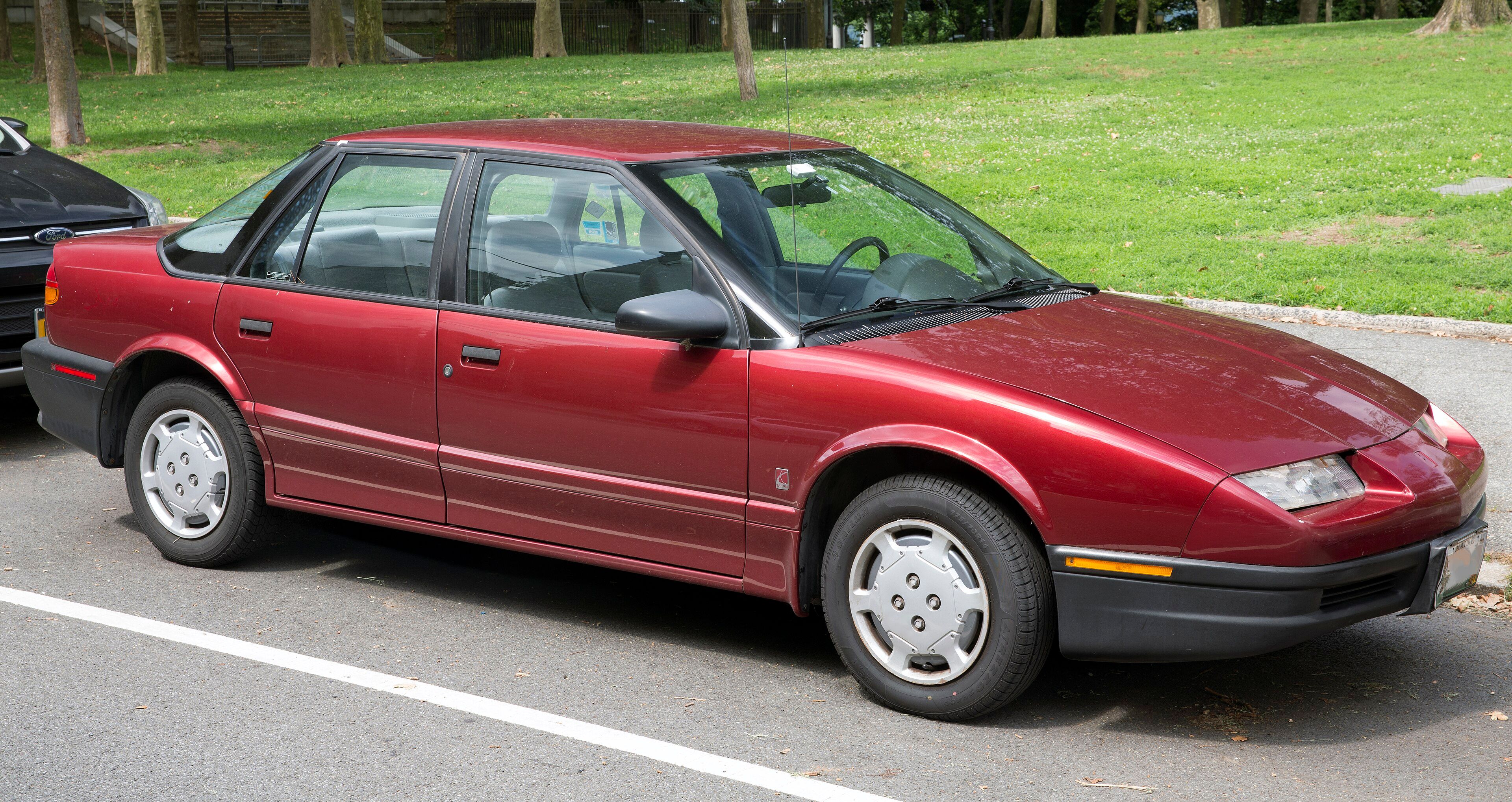 1995 Saturn SL1 sedan in maroon, front right view