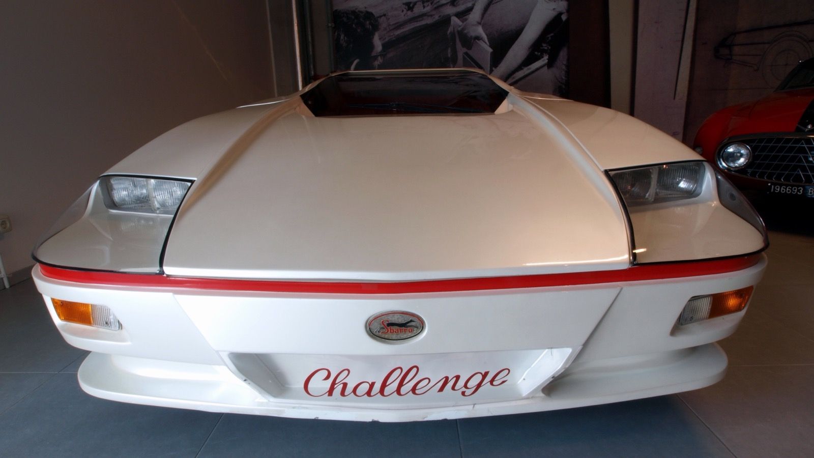 White 1985 Sbarro Challenge concept, front view showing pop-up headlamps and Sbarro badge