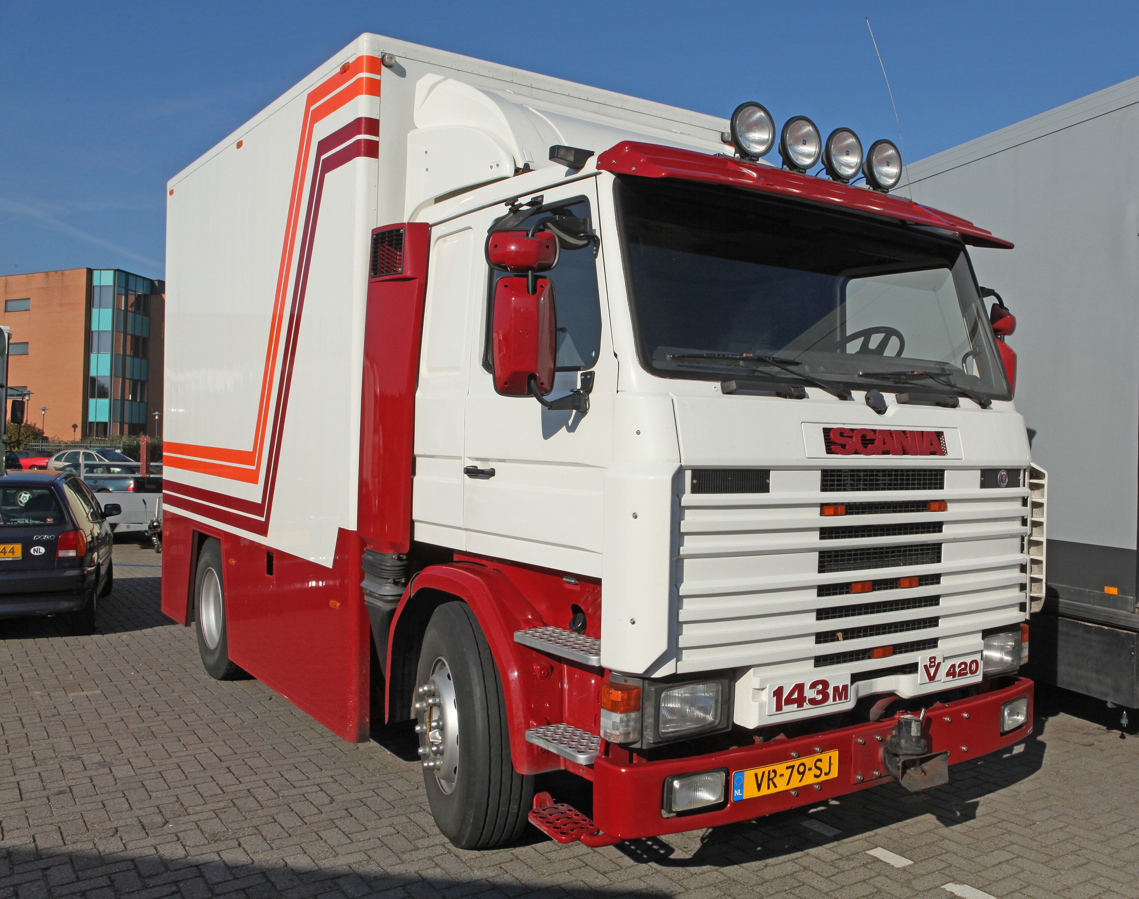 White and red 1992 Scania 143M V8 420 box truck, front three-quarter view