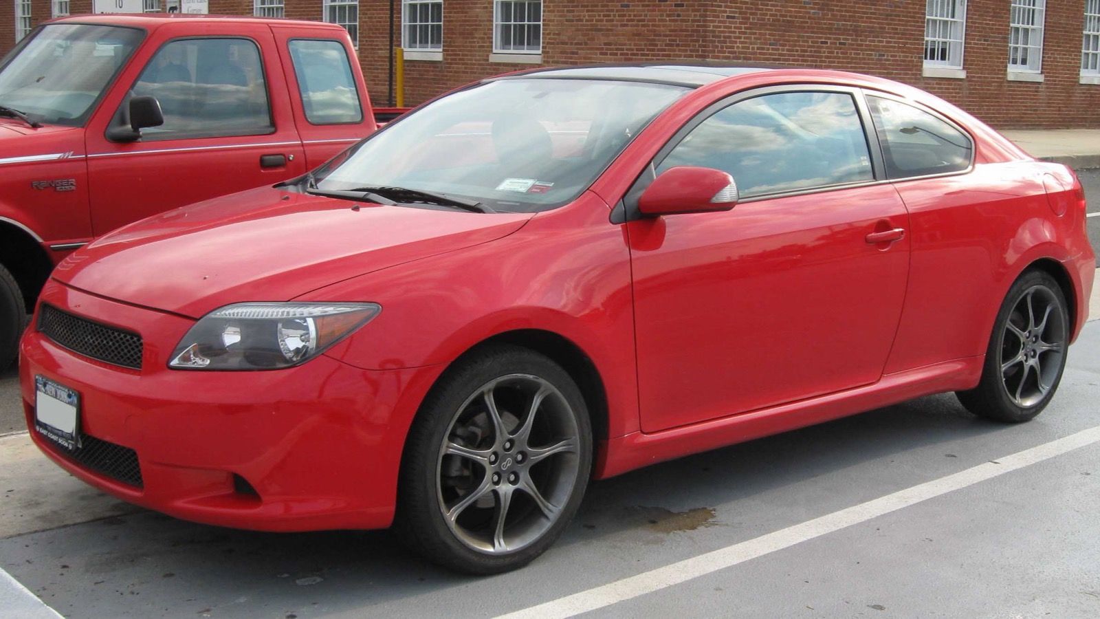 Red 2005 Scion tC first-generation coupe, front three-quarter view