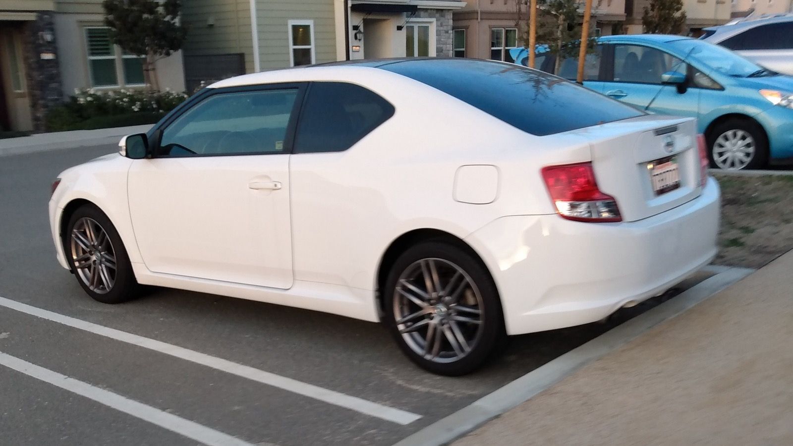 White 2011 Scion tC coupe, rear three-quarter view