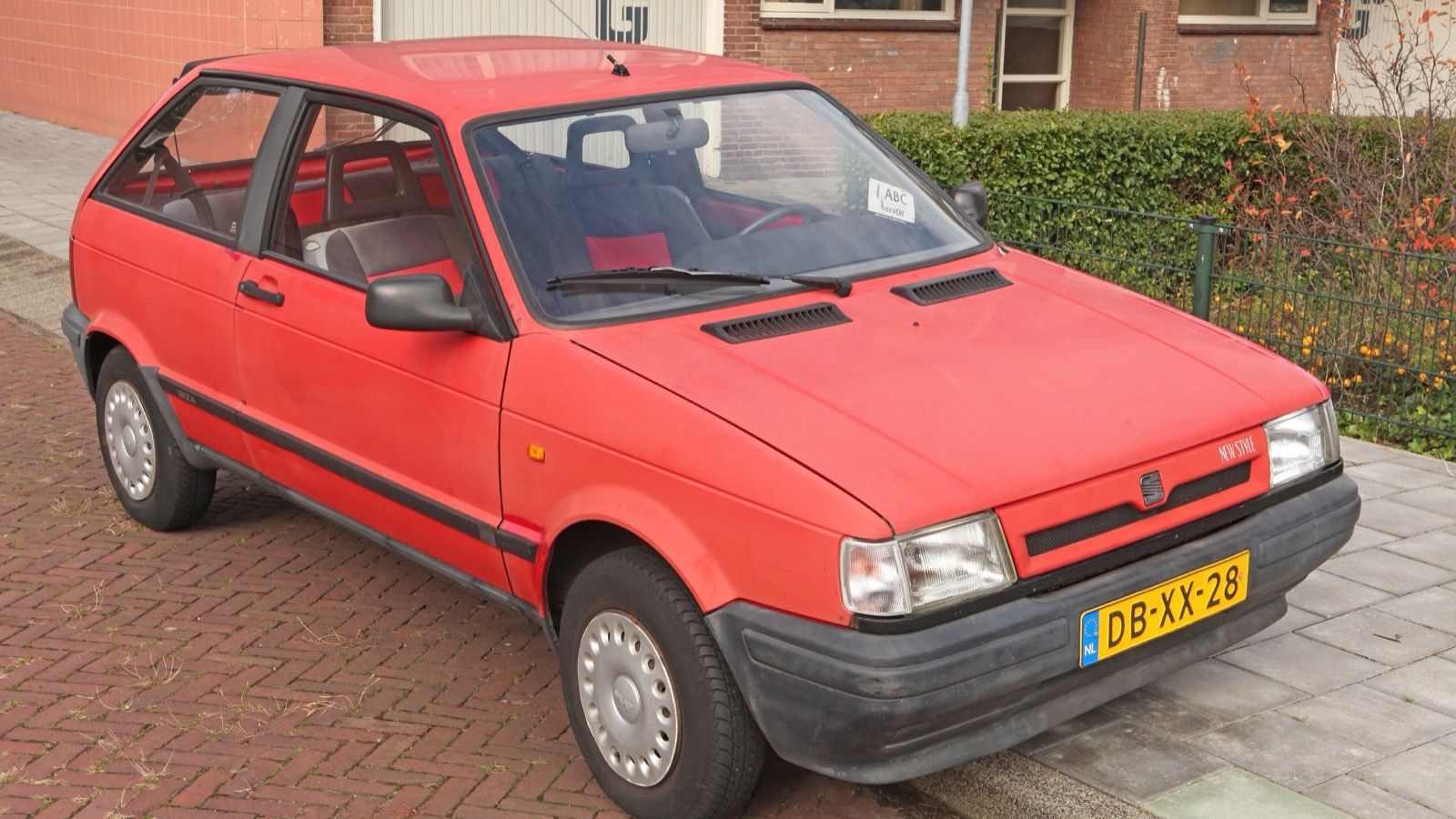 Red 1991 SEAT Ibiza Mk1 'New Style' three-door hatchback, front three-quarter view
