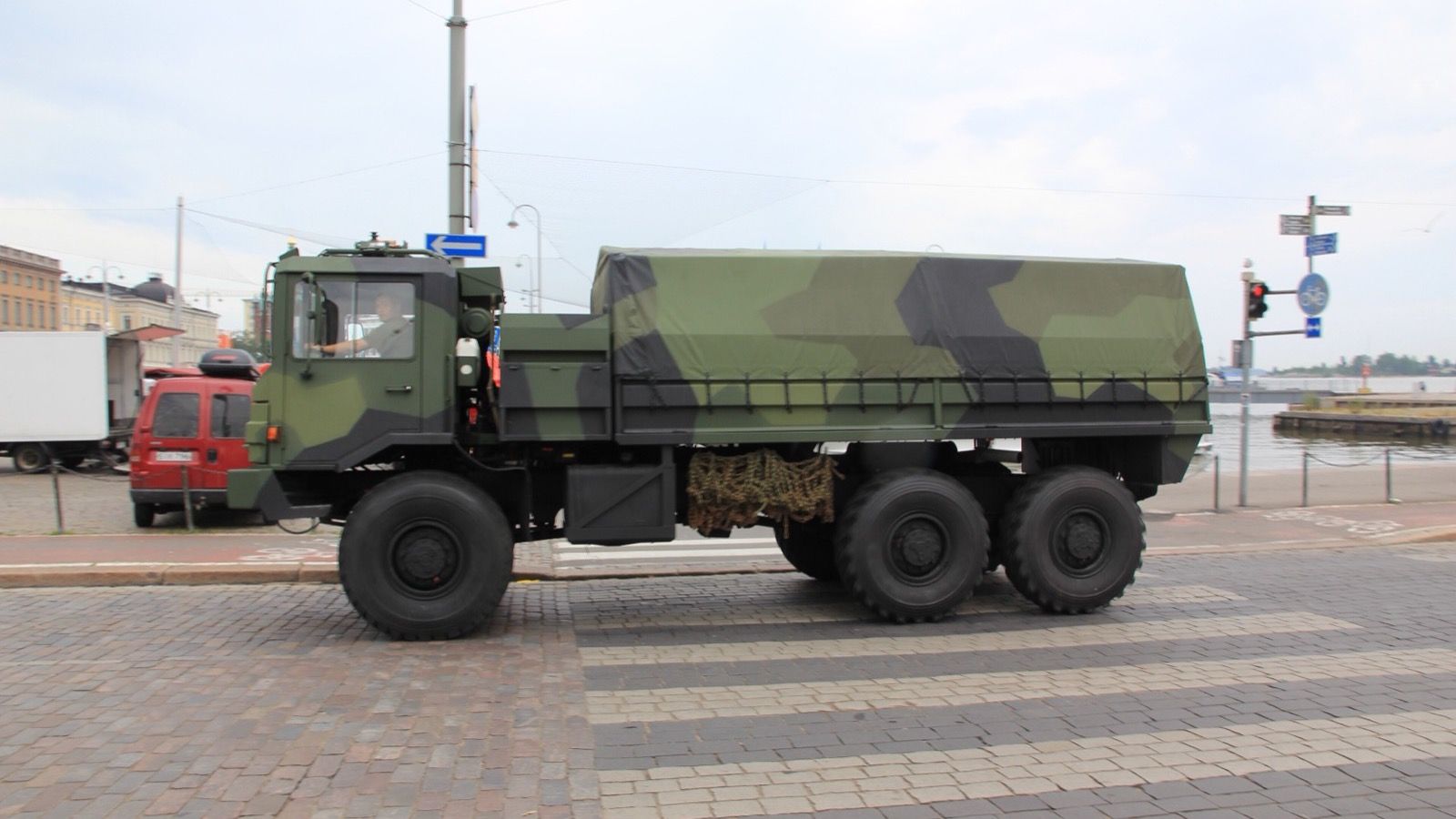 Camouflaged Sisu SA-240 6x6 military cargo truck, side profile