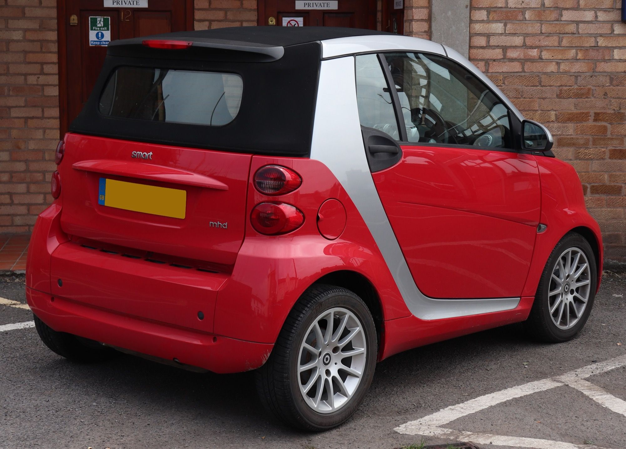 Red 2011 Smart Fortwo Passion MHD cabriolet (W451), rear three-quarter view