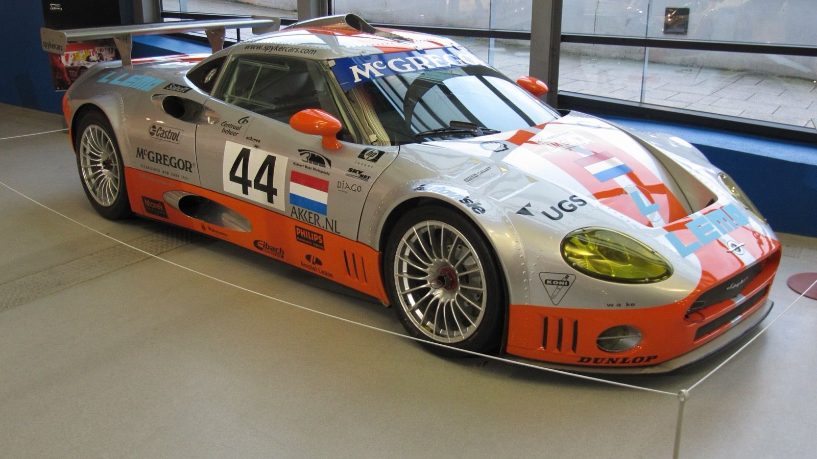 Silver-and-orange 2002 Spyker C8 Double 12 endurance racer, front three-quarter view