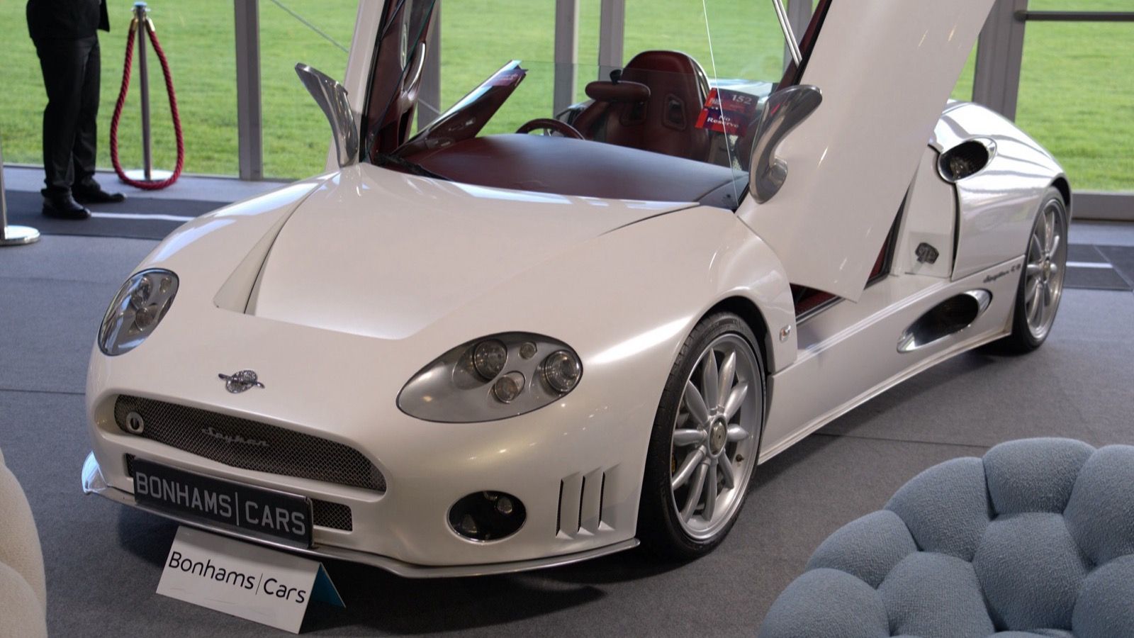 White 2006 Spyker C8 Spyder with doors raised, front three-quarter view