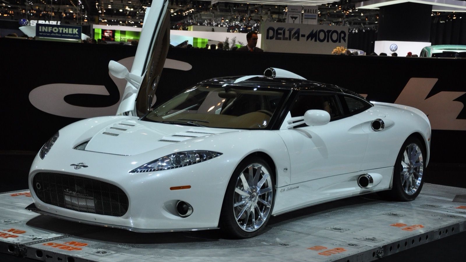 White Spyker C8 Aileron coupe with a door raised, front three-quarter view