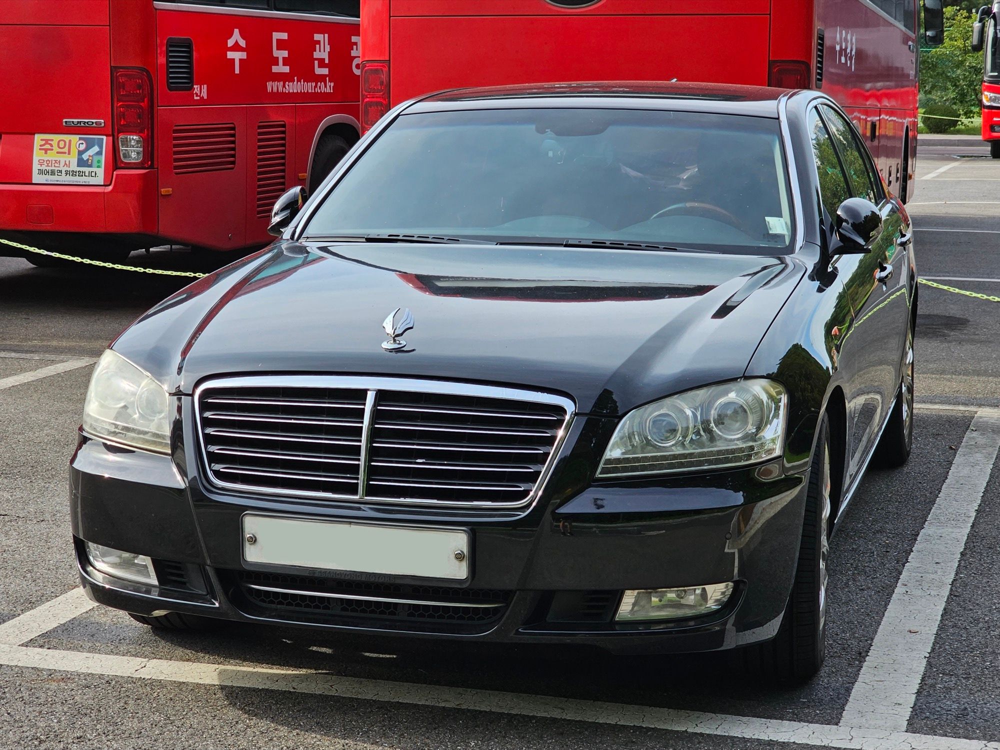 Black SsangYong Chairman W CW600 sedan, front three-quarter view