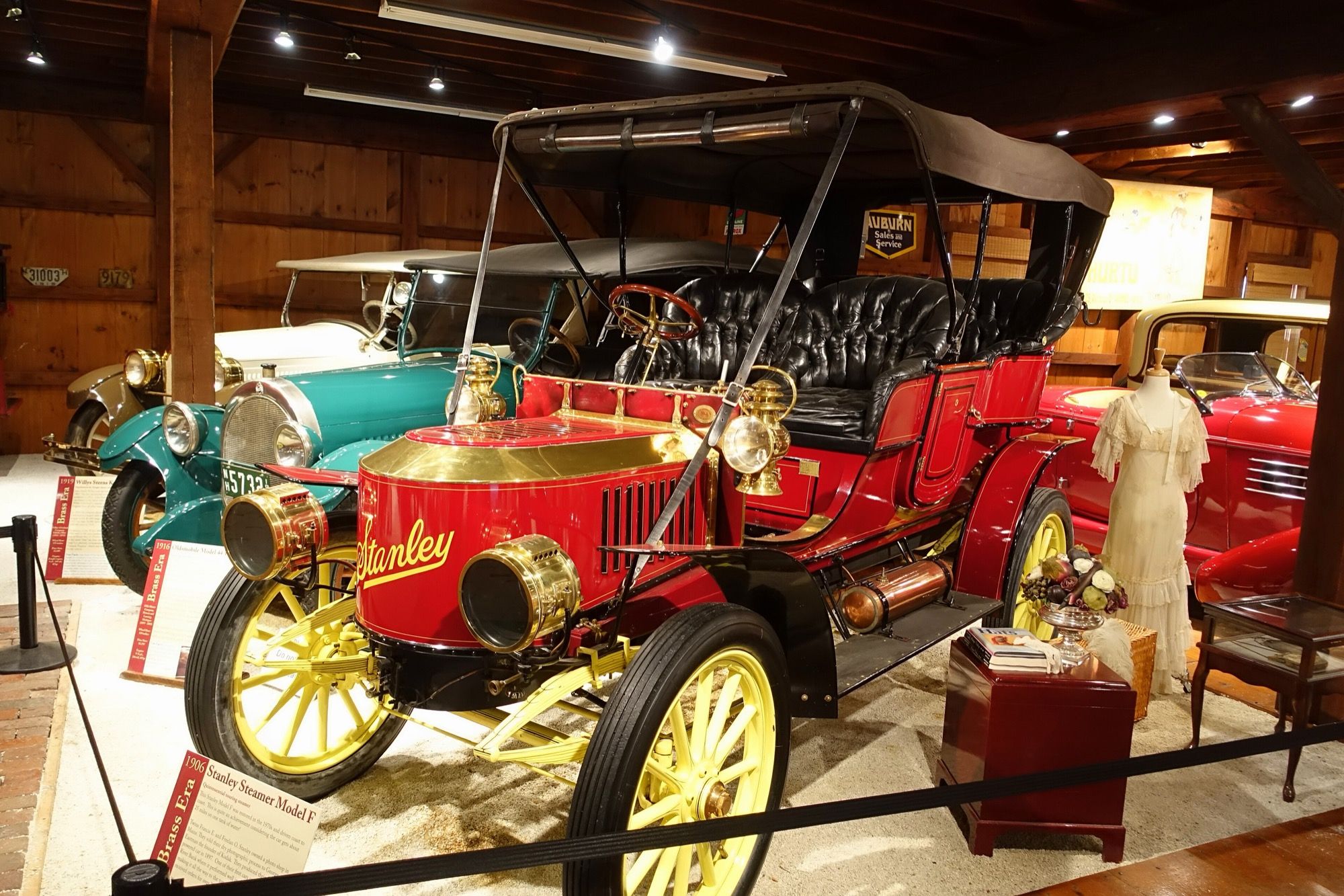 Red 1906 Stanley Steamer Model F with brass coffin-nose hood, front three-quarter view