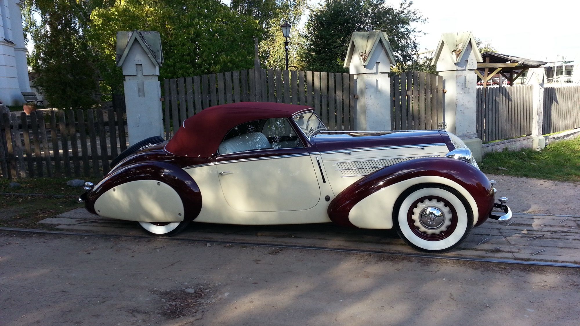 Maroon and cream 1939 Steyr 220 Gläser Roadster, left side profile