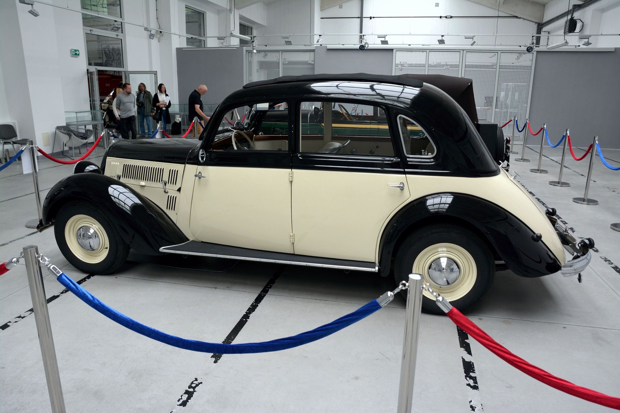 Black and cream Stoewer Sedina four-door saloon on museum display, side profile
