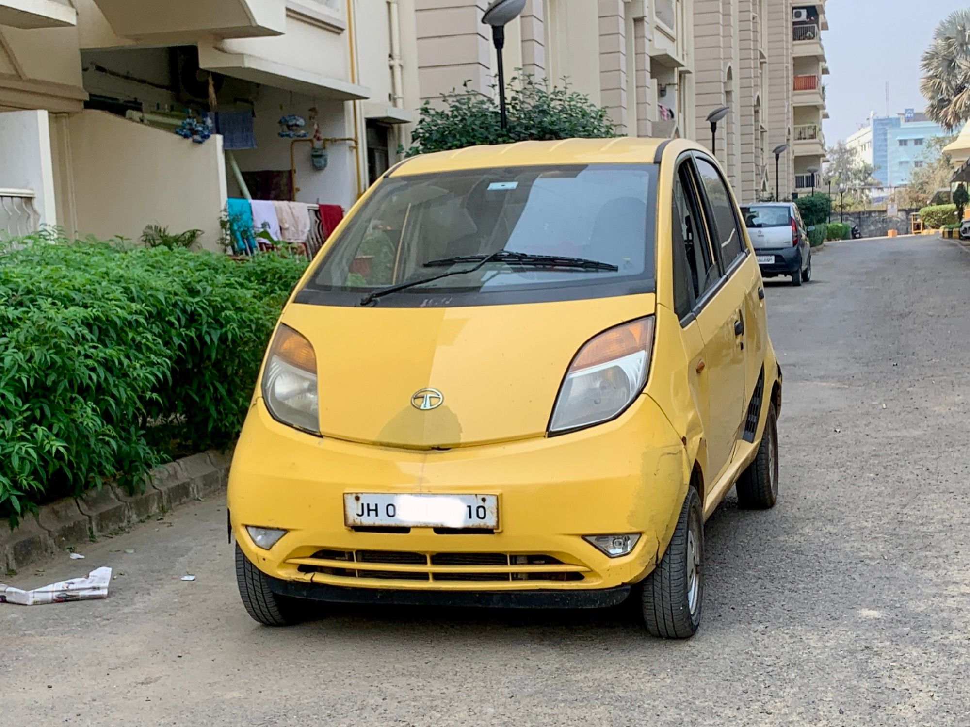 Yellow first-generation Tata Nano microcar, front three-quarter view