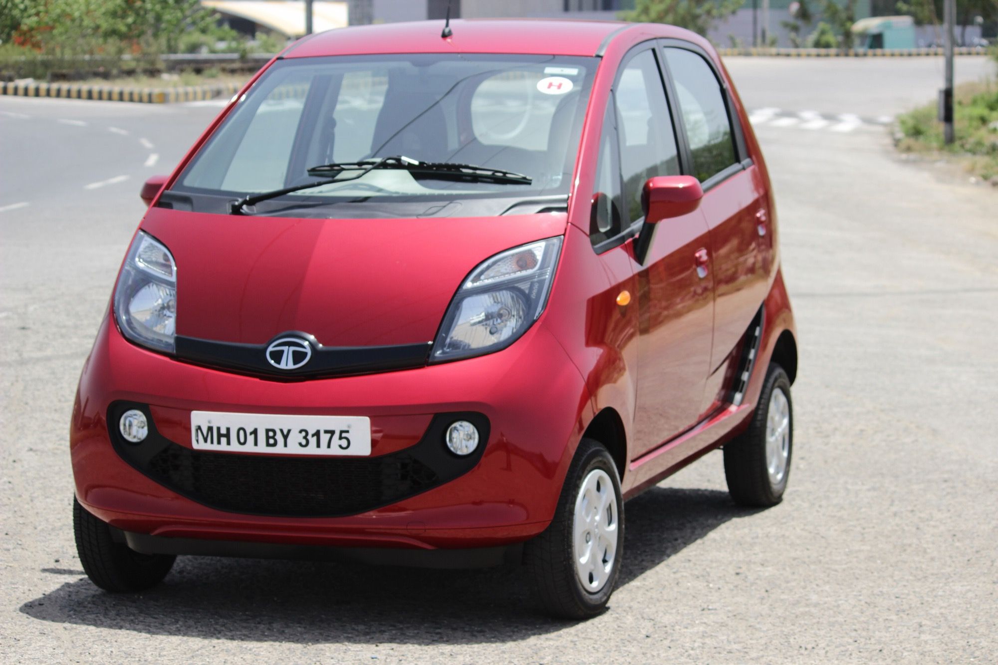 Red Tata GenX Nano microcar, front three-quarter view