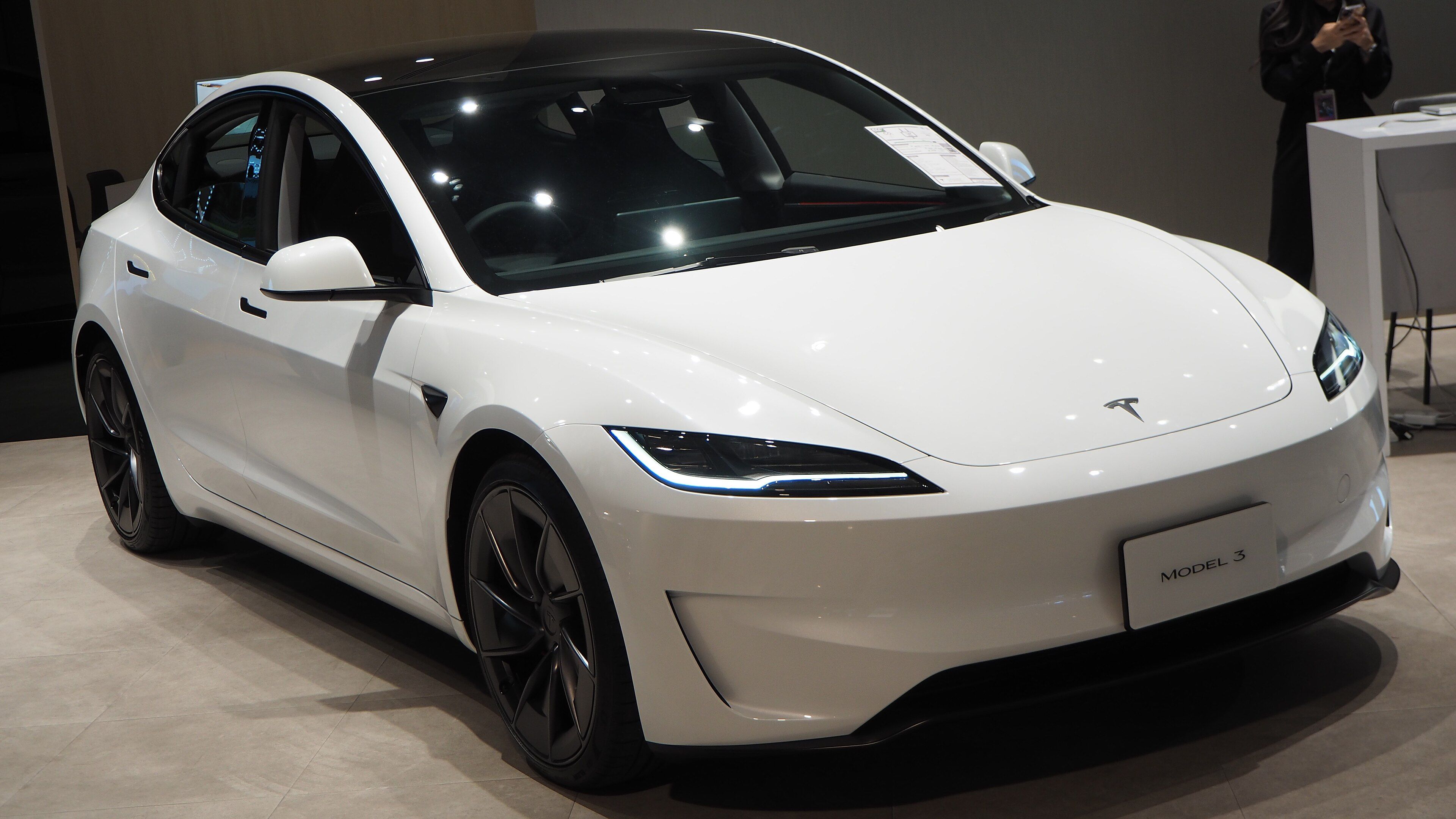 White 2024 Tesla Model 3 Highland Performance, front three-quarter view