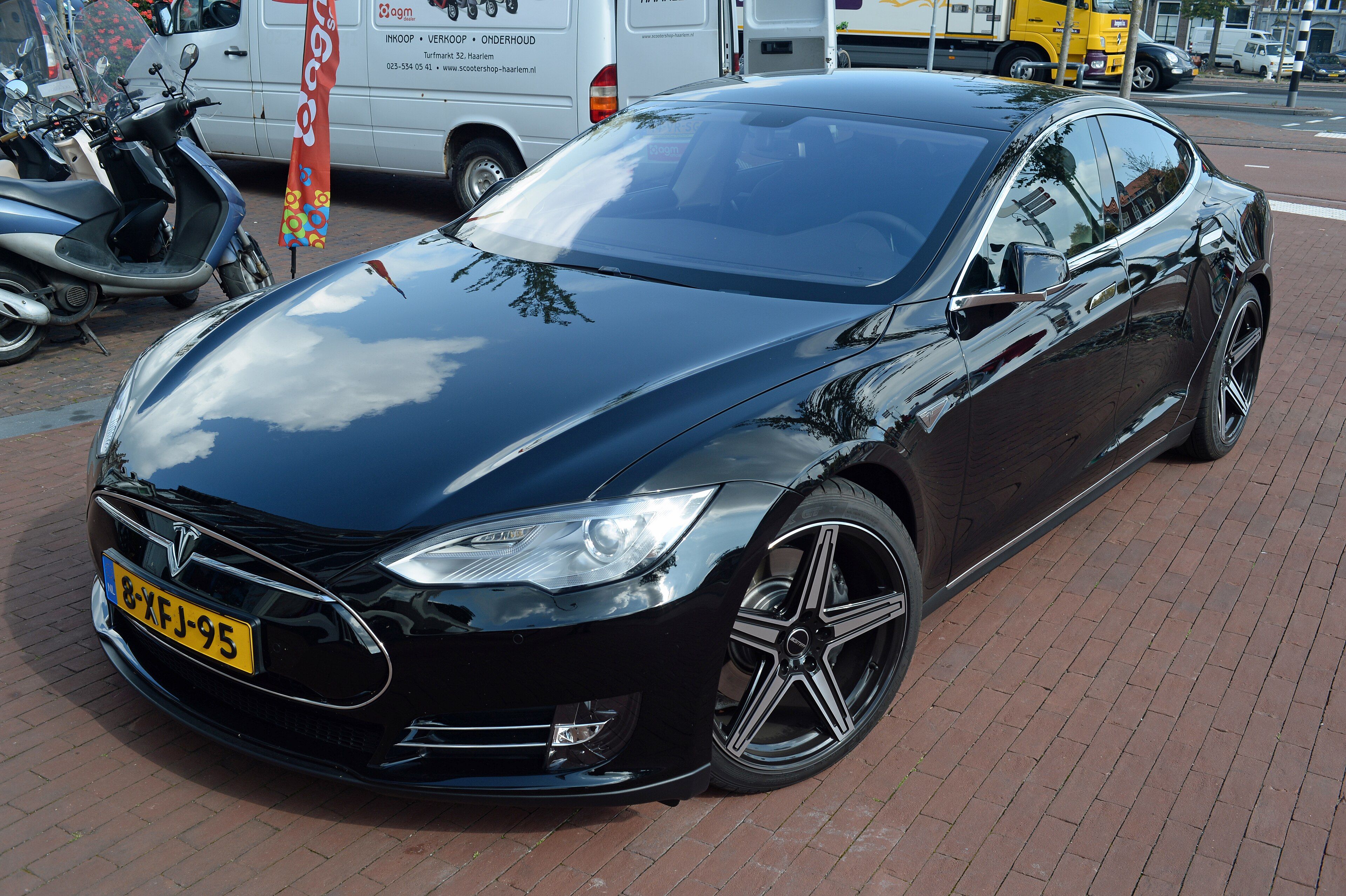 Black 2014 Tesla Model S with nosecone grille, front three-quarter view