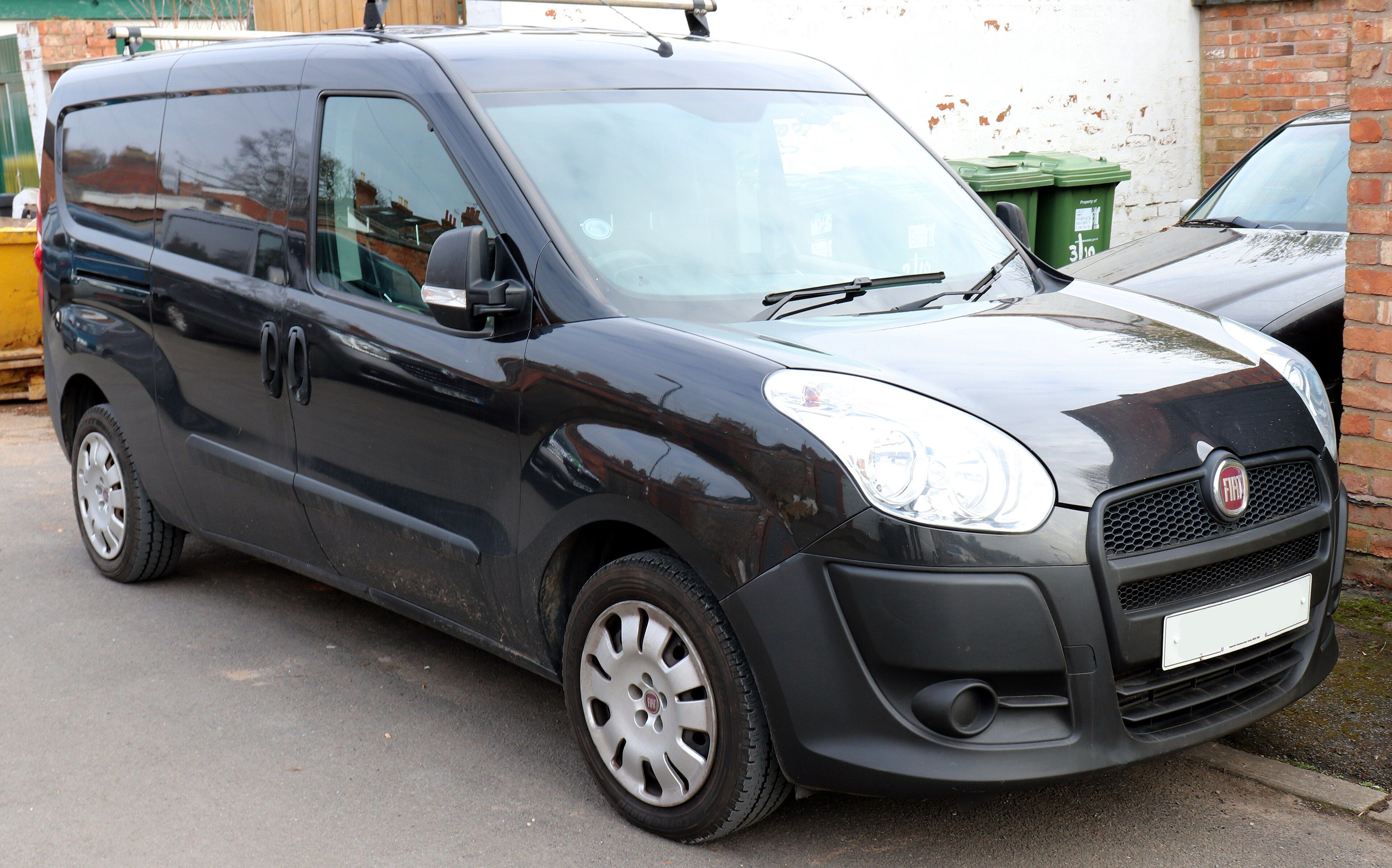 Black second-generation Fiat Doblò (Type 263) panel van, front three-quarter view